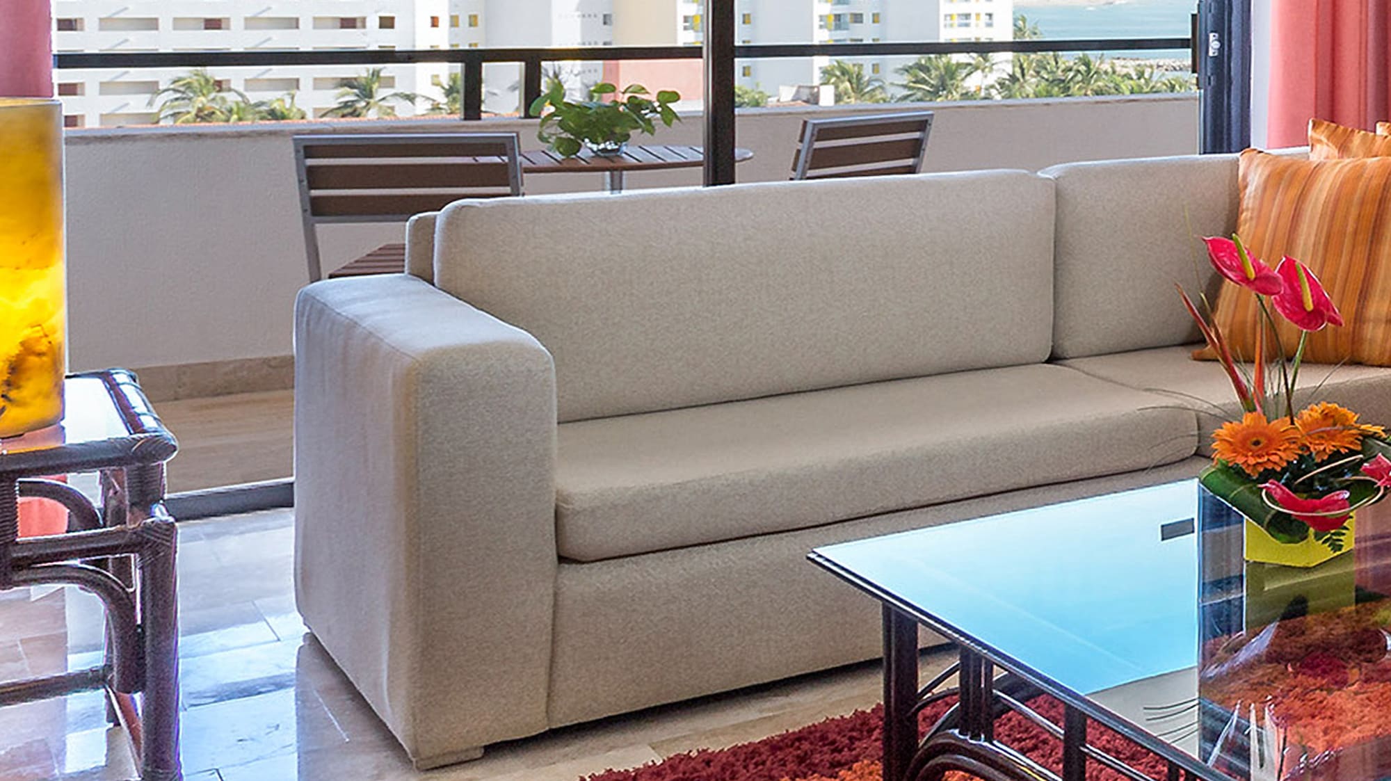 a living room with a couch and a glass table