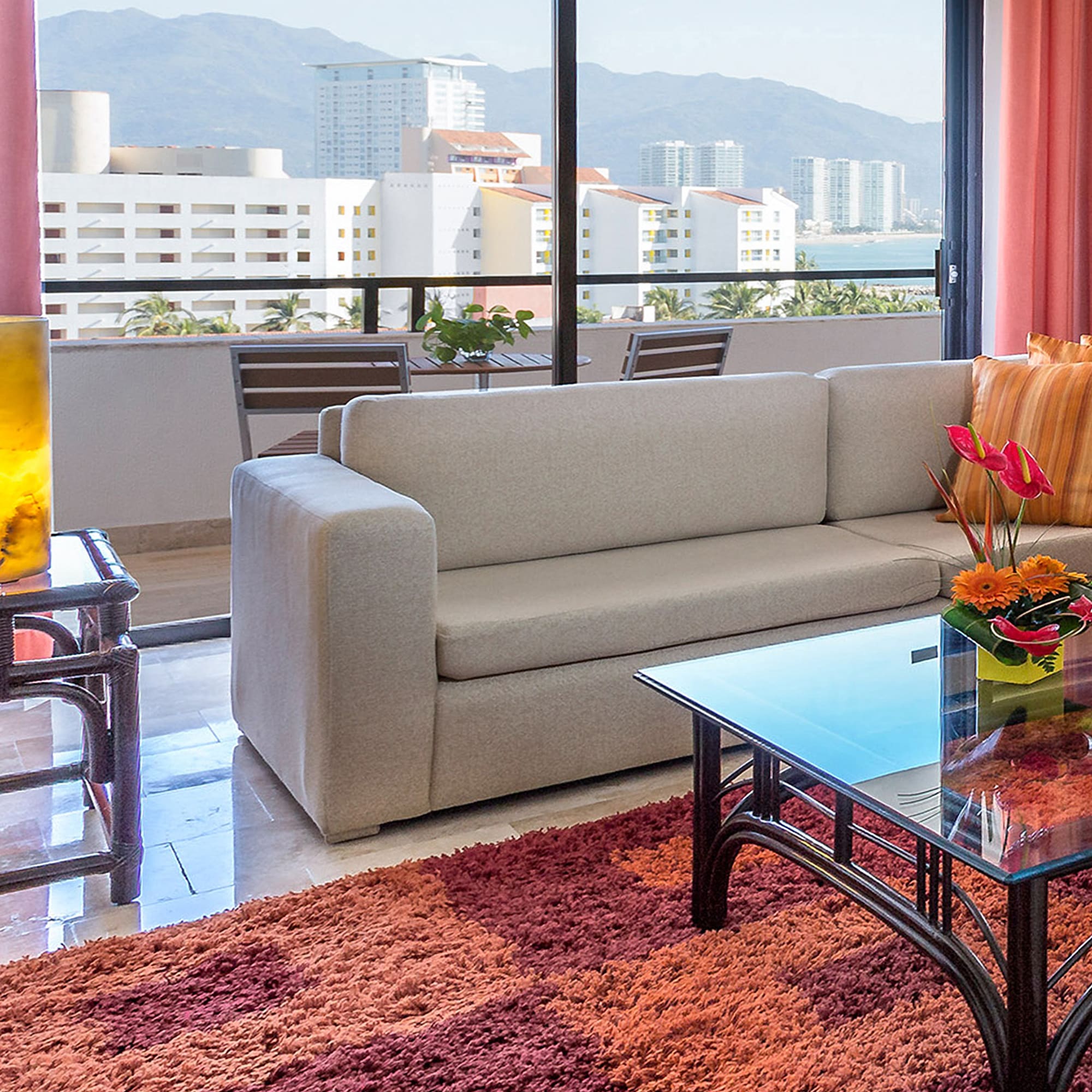 a living room with a couch and a glass table