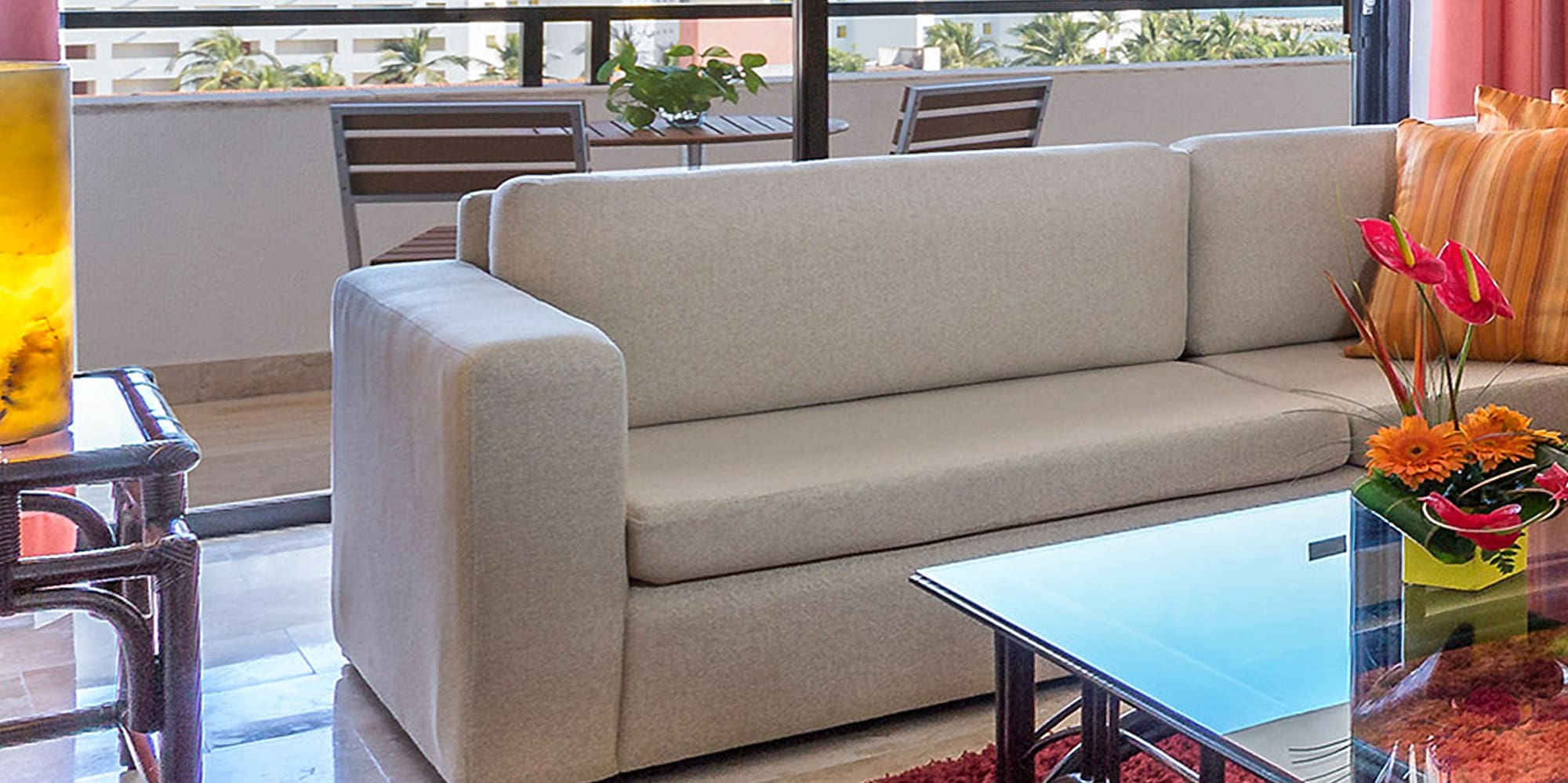 a living room with a couch and a glass table