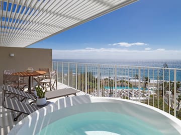 a hot tub with a view of the ocean