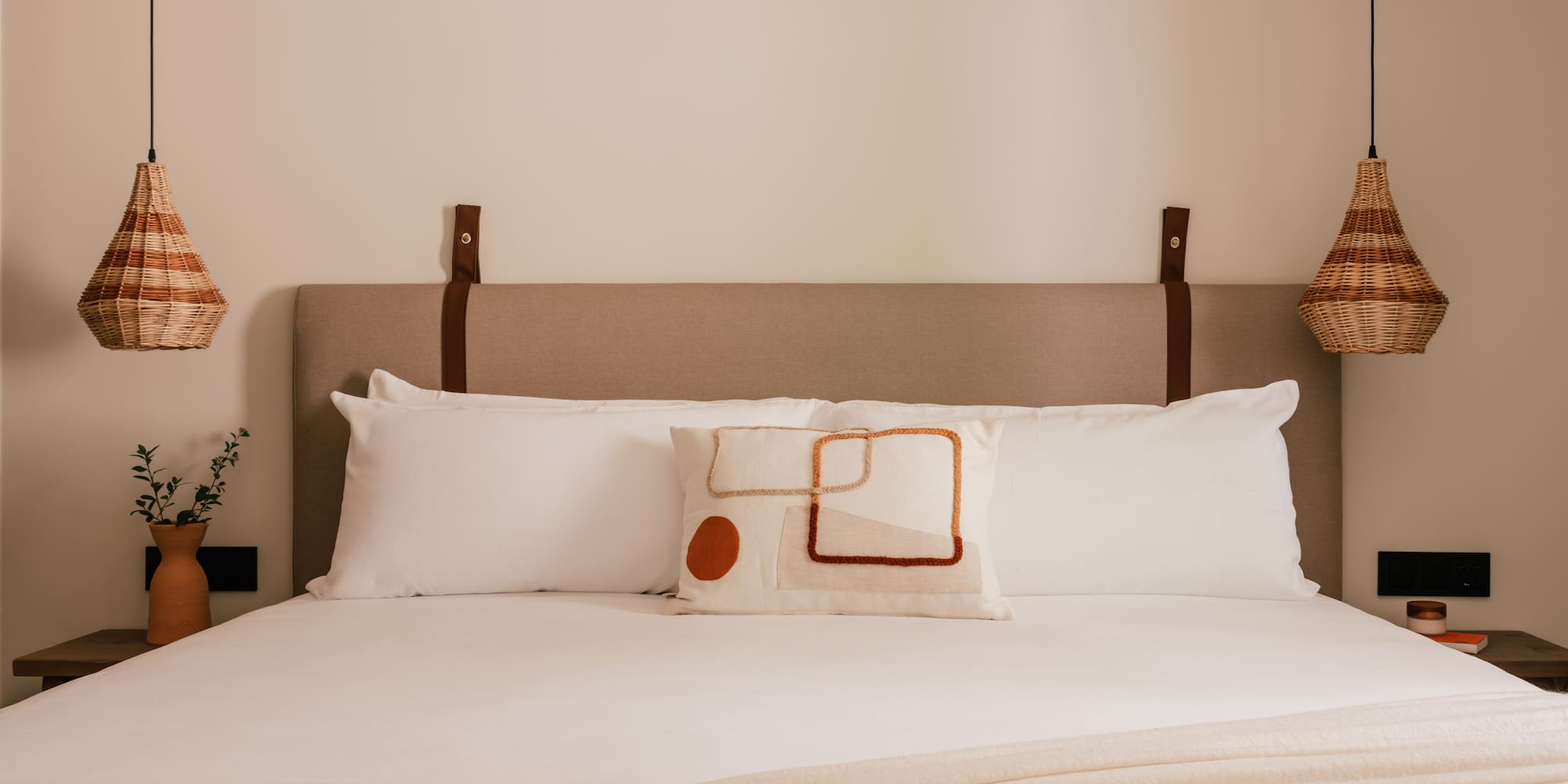 a bed with pillows and a lamp