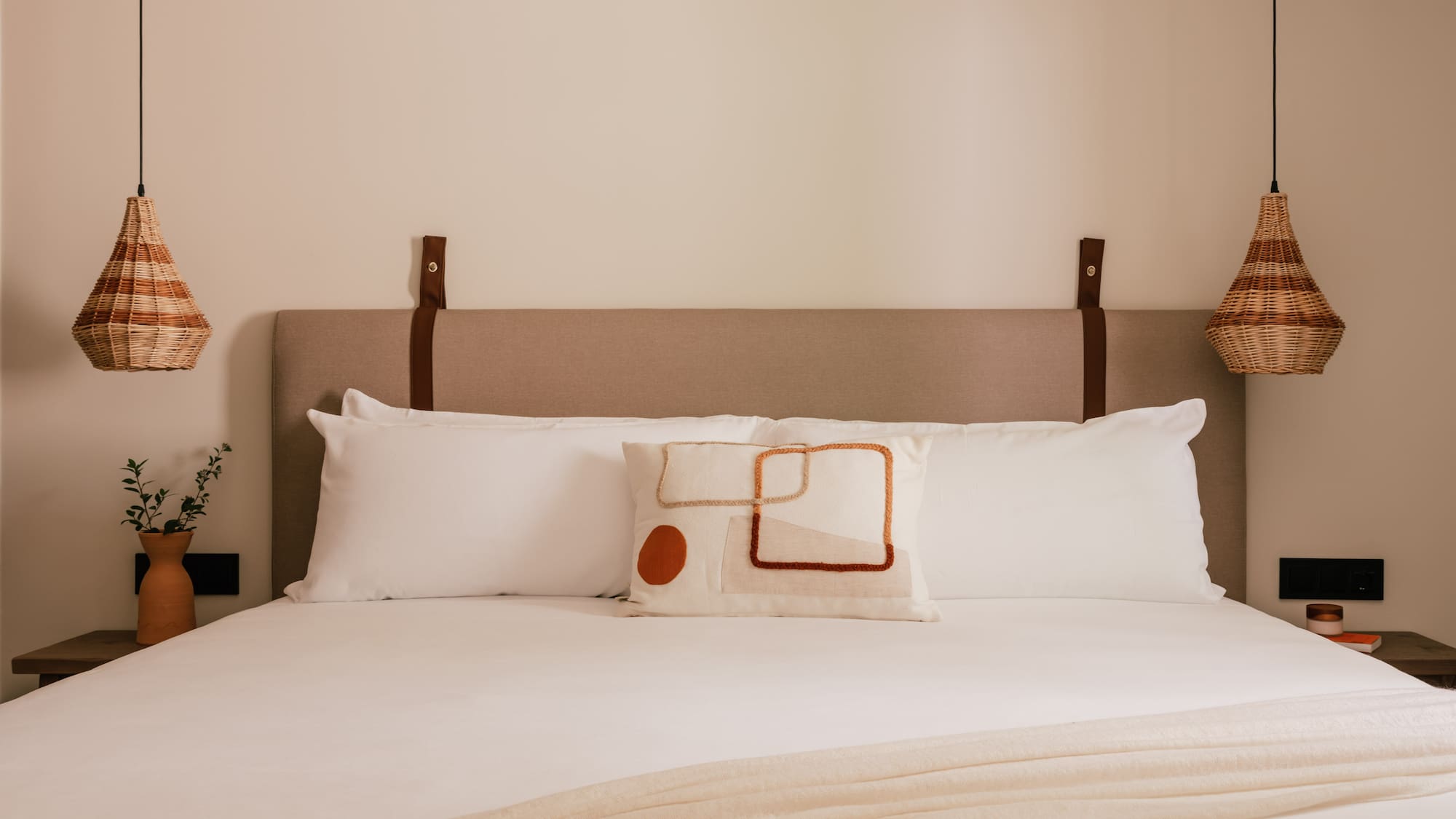 a bed with pillows and a lamp