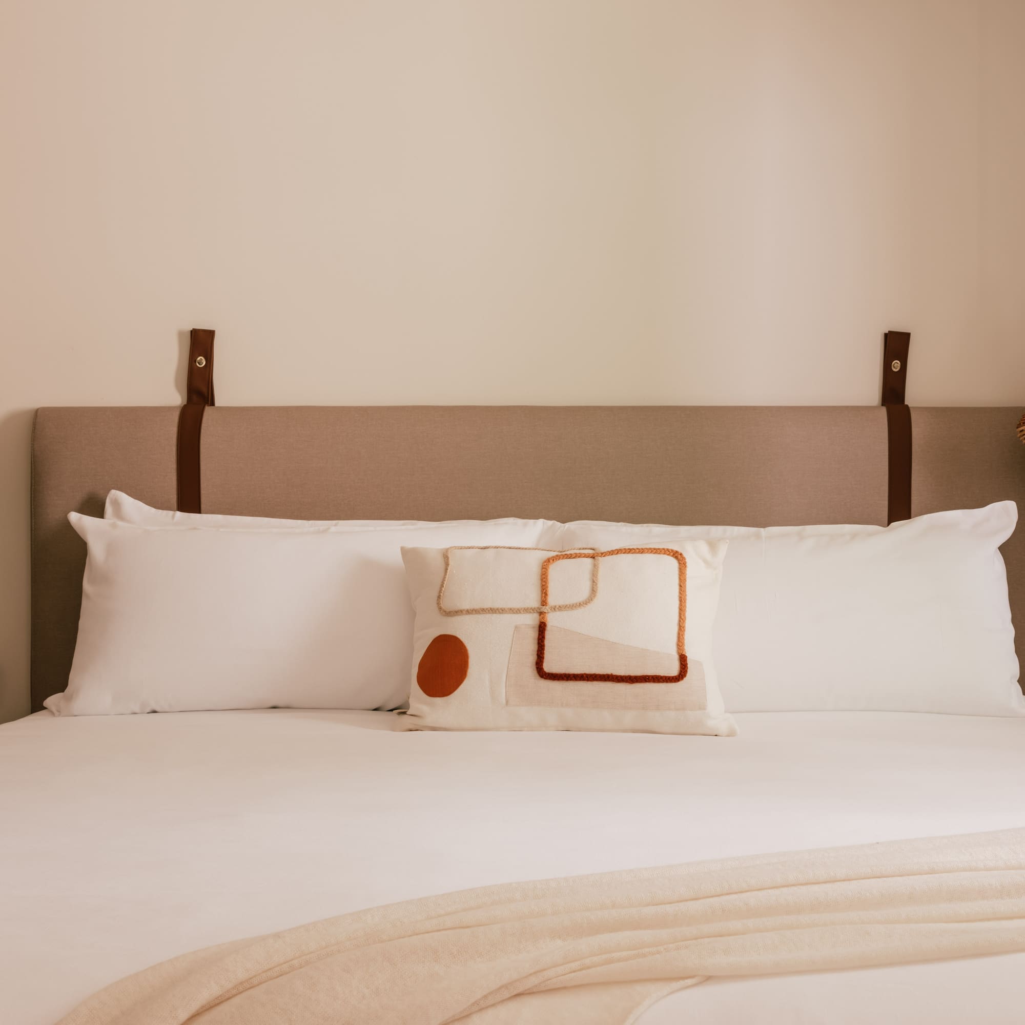 a bed with pillows and a lamp