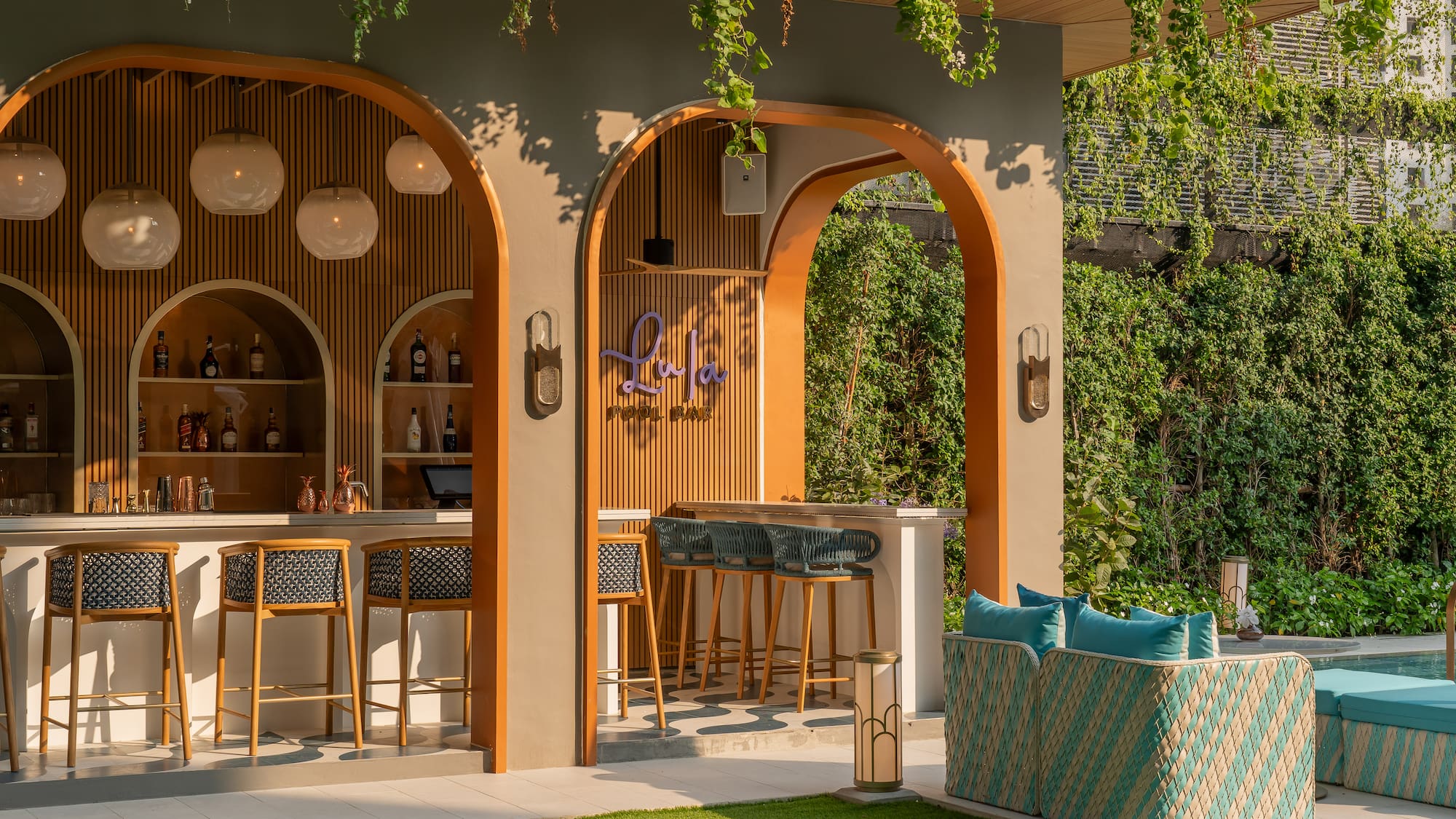 a bar with chairs and a bench in front of a patio