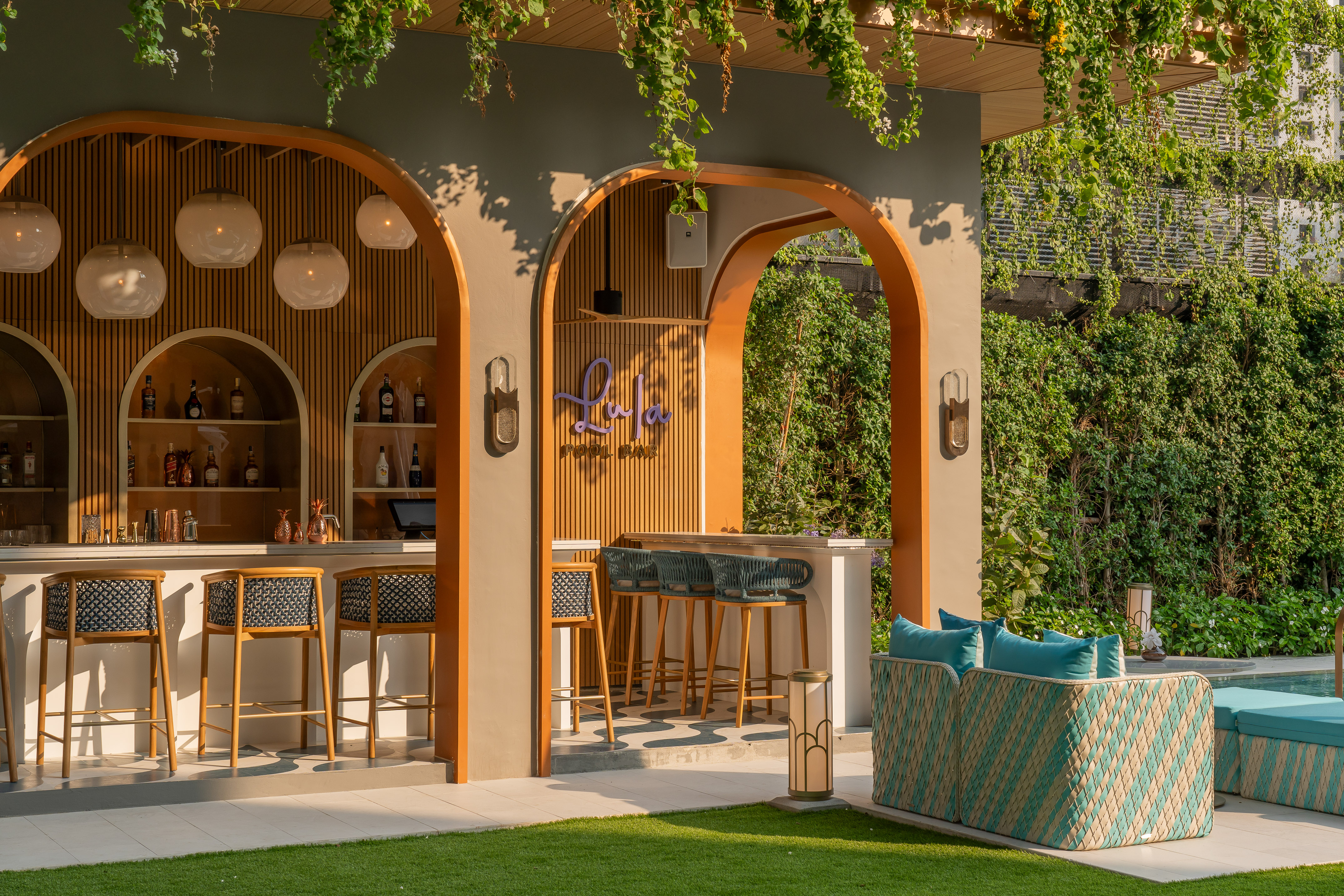 a bar with chairs and a bench in front of a patio
