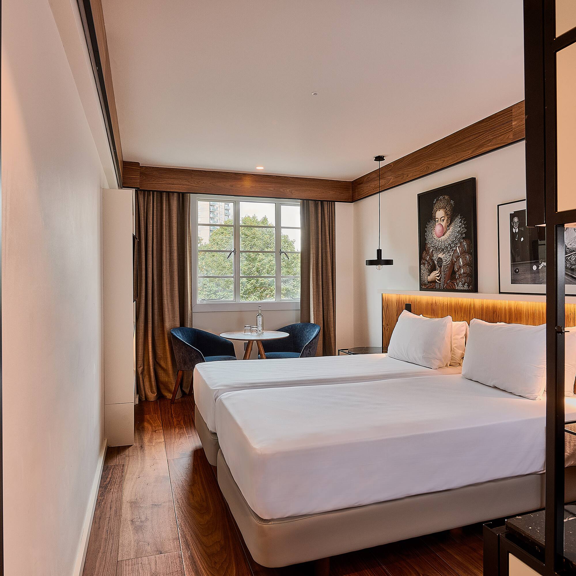 a room with two beds and a table