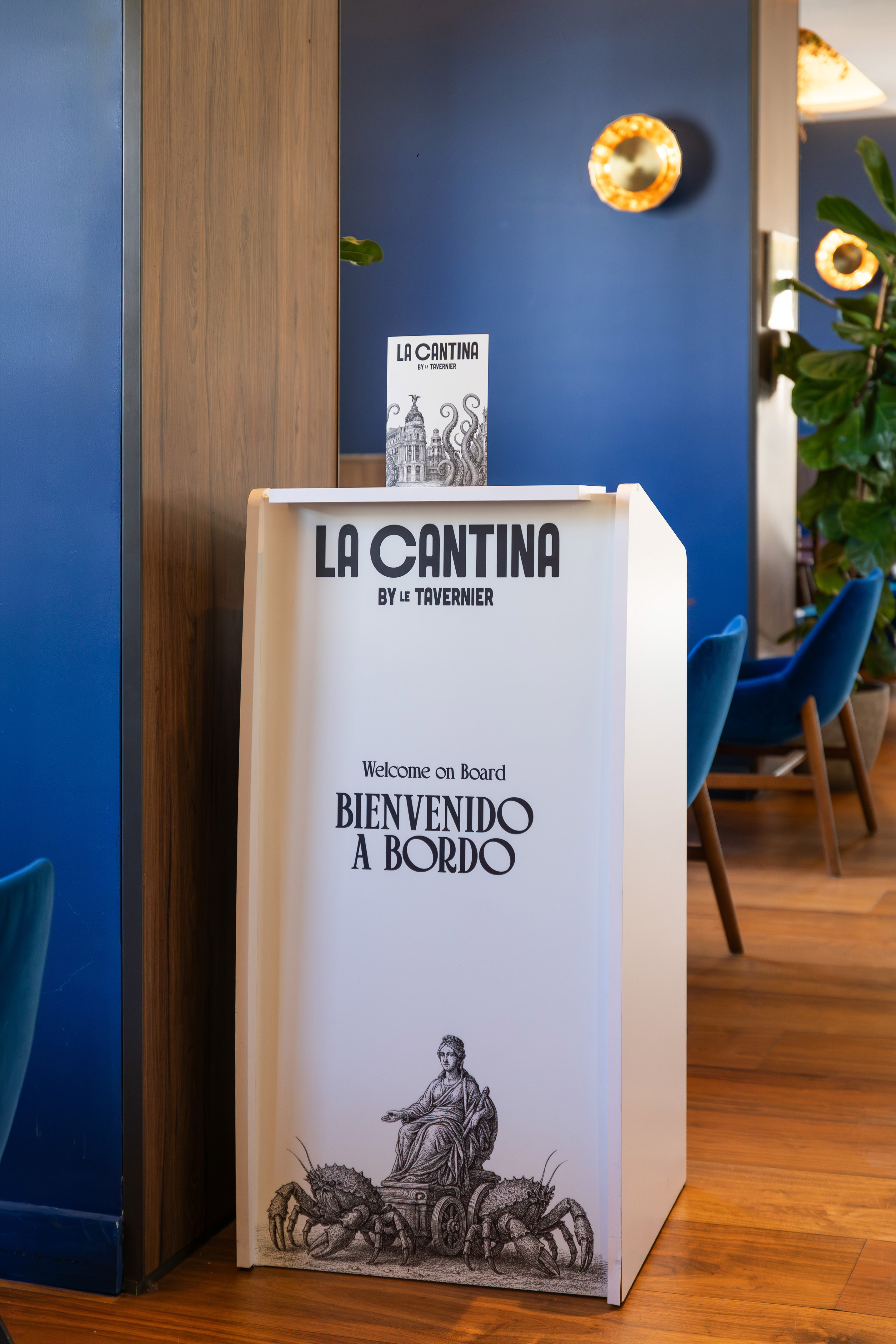La Cantina restaurant welcome sign with "Bienvenido a Bordo" and crab art.