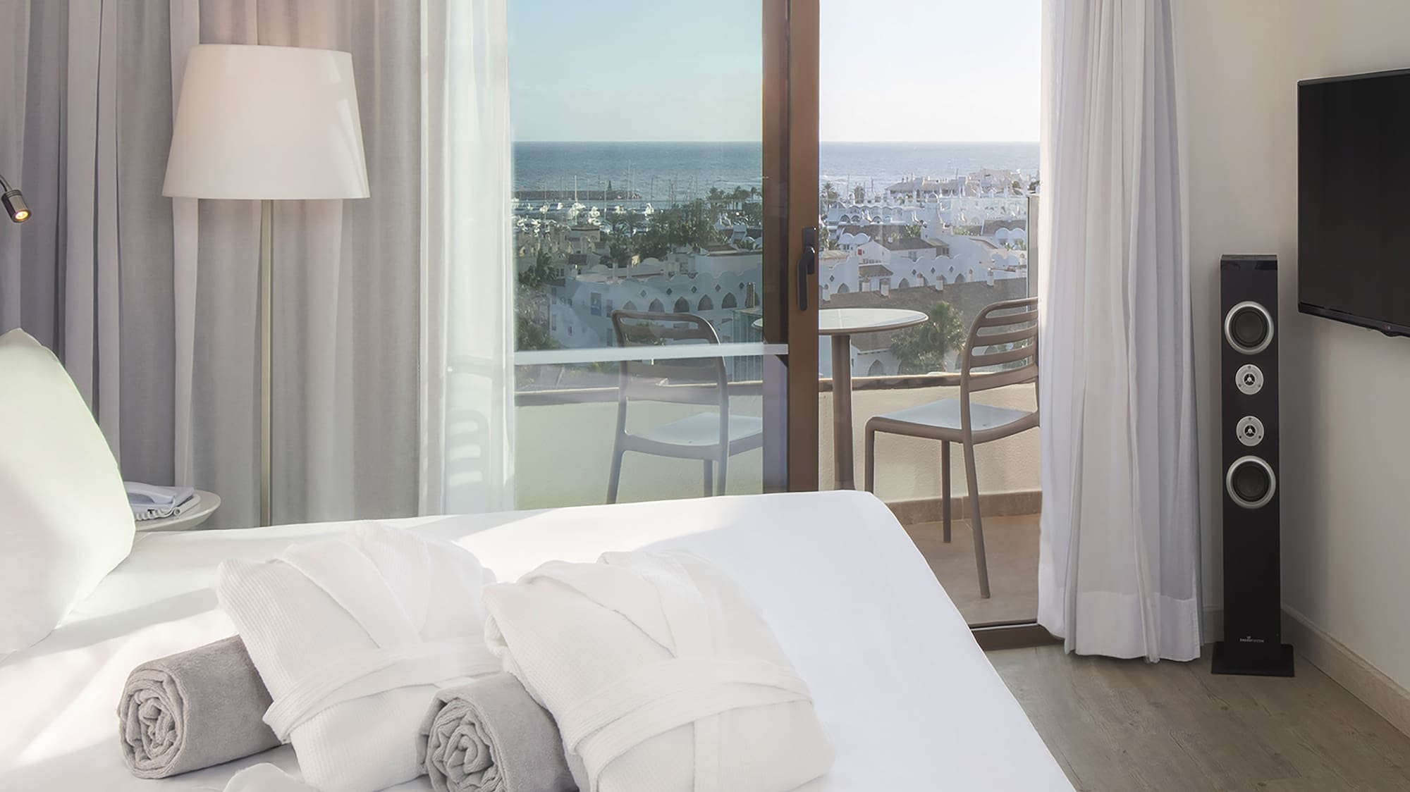 a bed with towels and a window