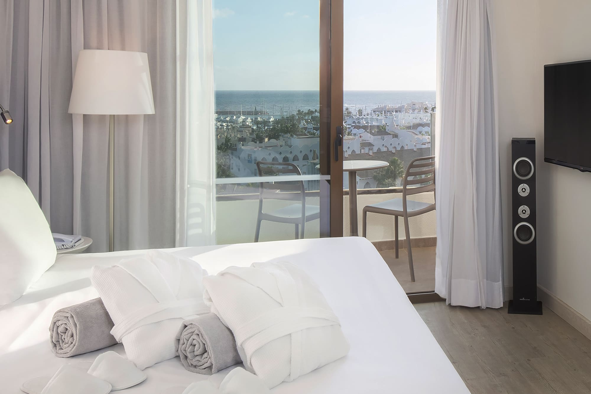 a bed with towels and a window