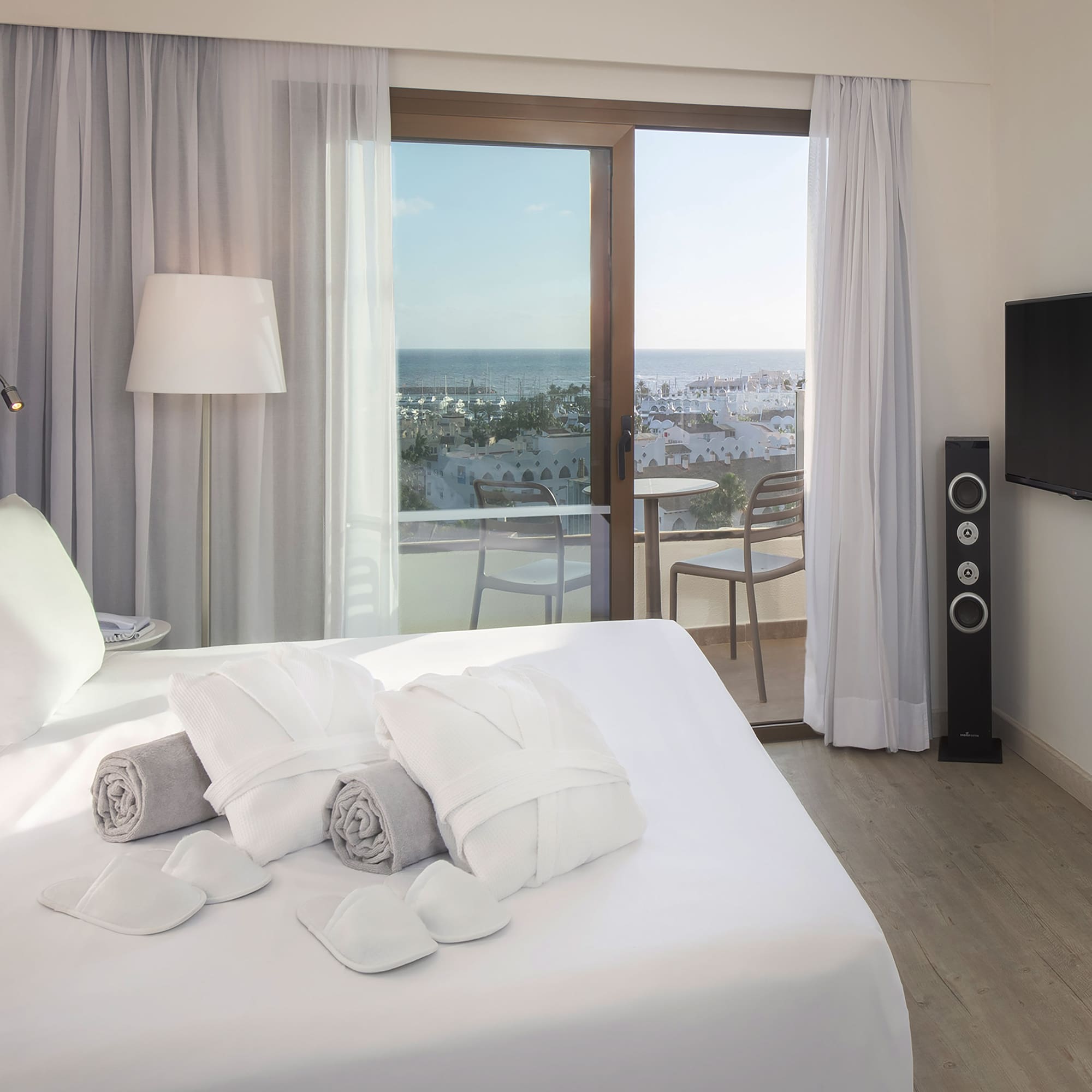 a bed with towels and a window