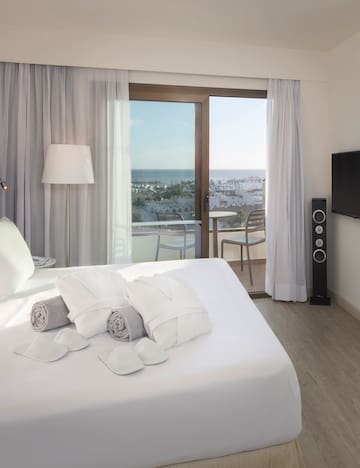 a bed with towels and a window