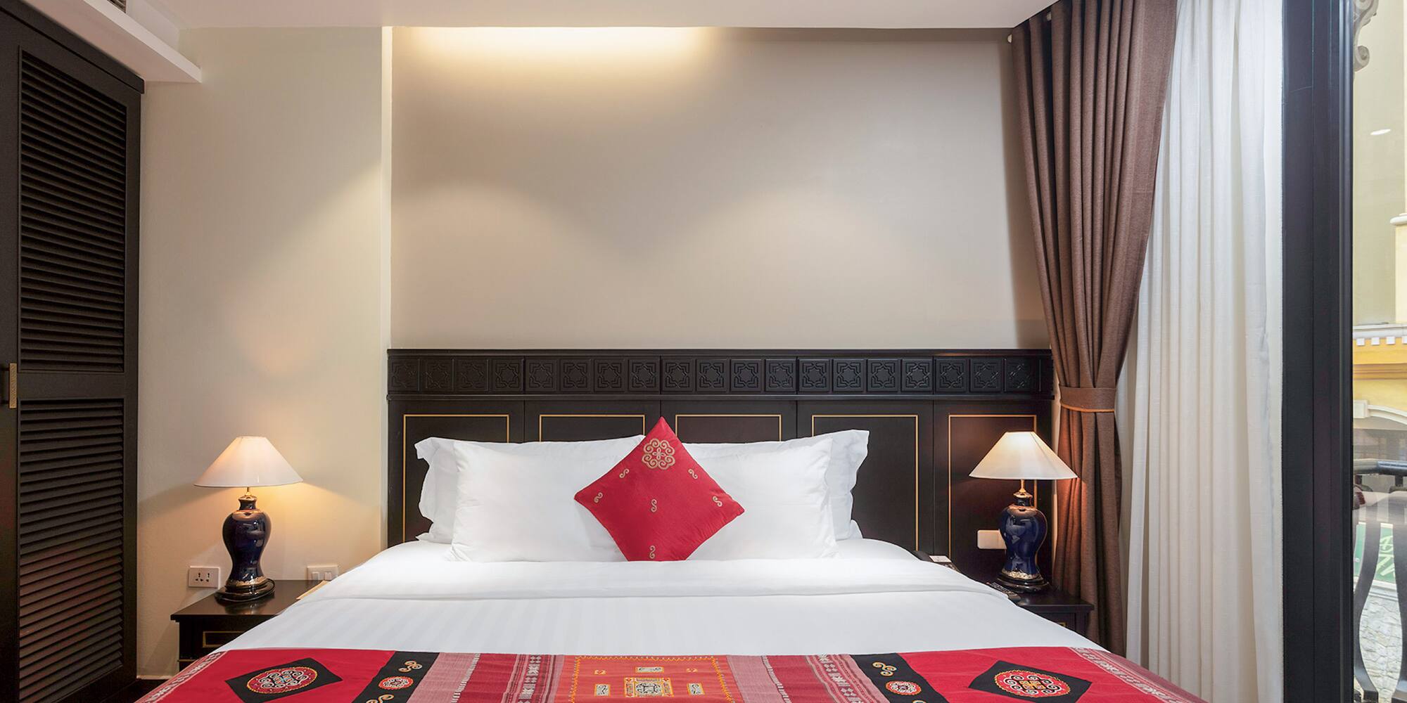 a bed with pillows and lamps in a room