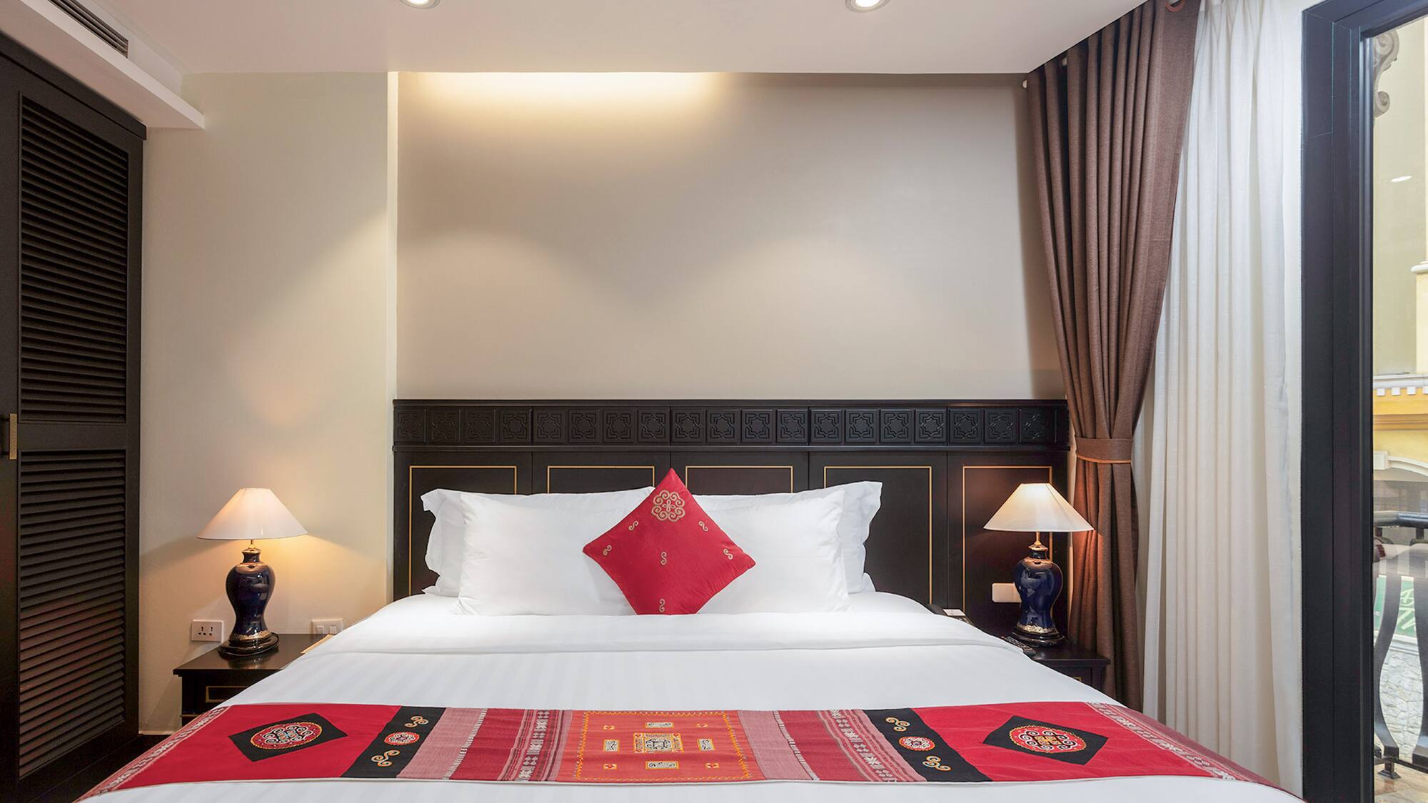 a bed with pillows and lamps in a room