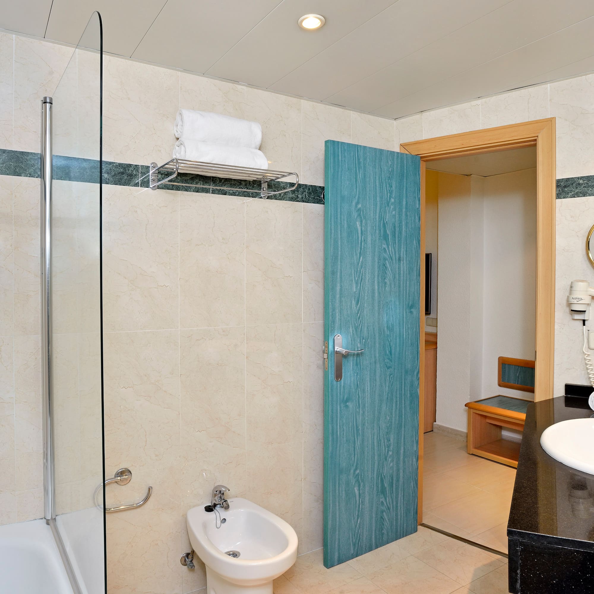 a bathroom with a blue door and a shower