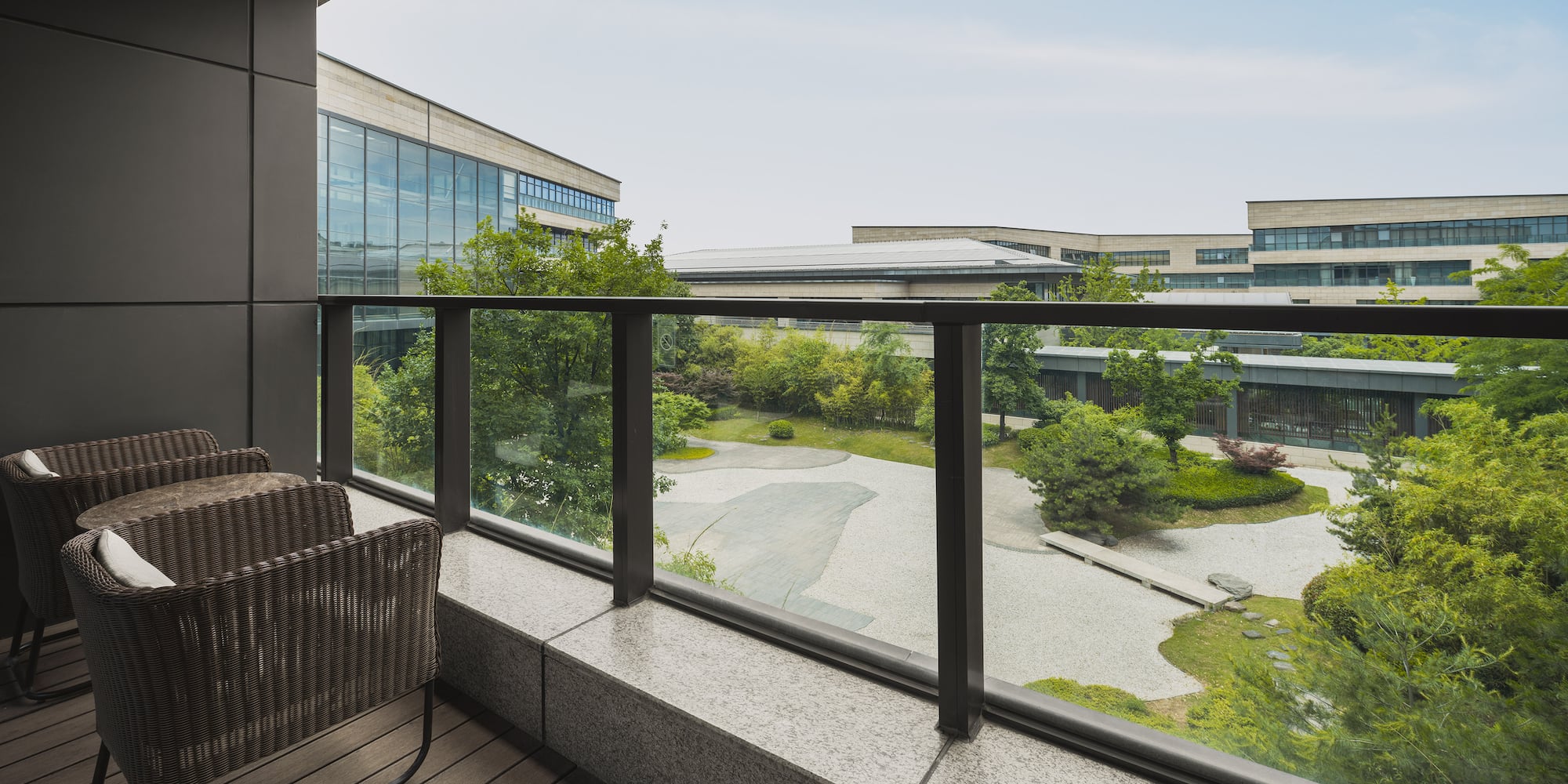 a balcony with a view of a city and trees