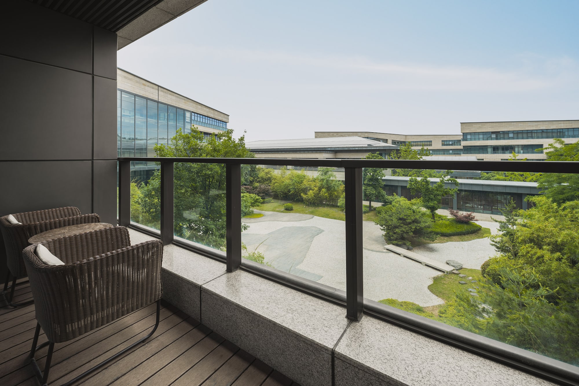 a balcony with a view of a city and trees