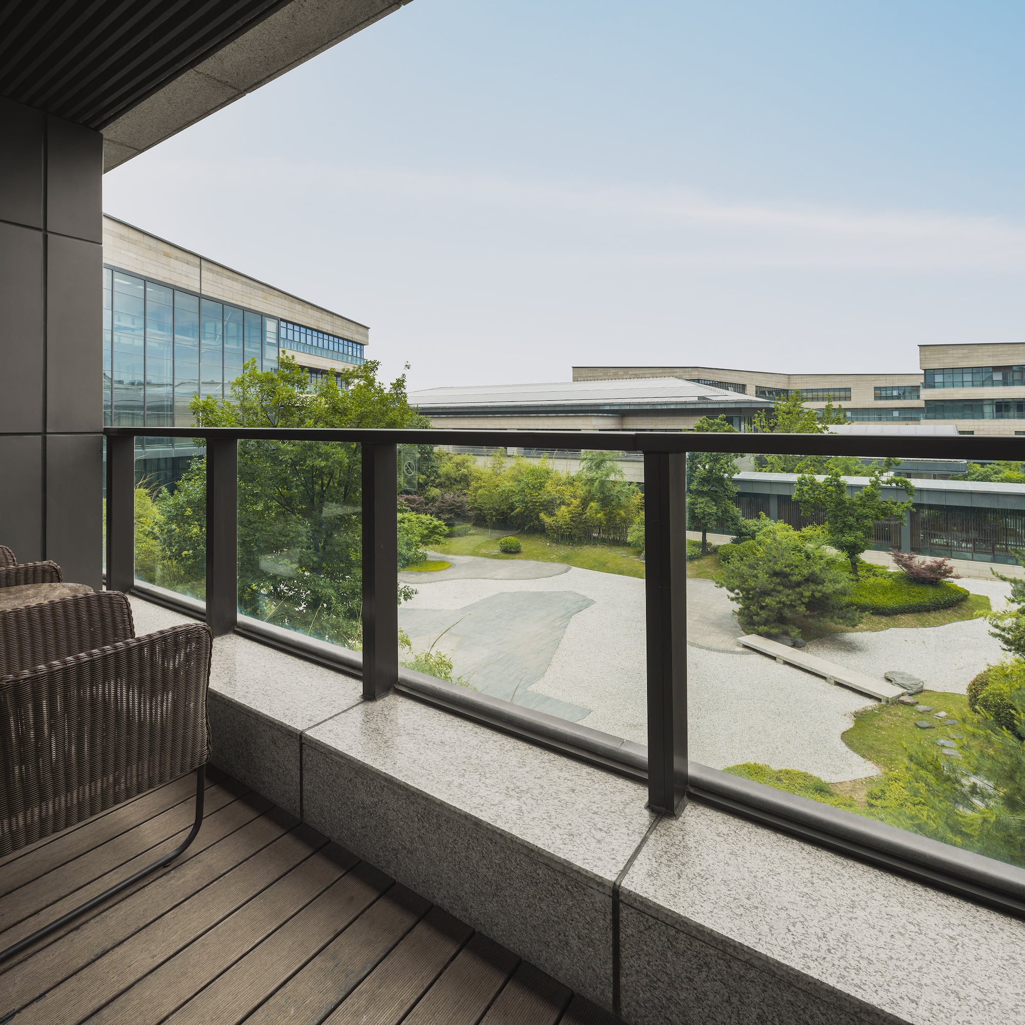 a balcony with a view of a city and trees