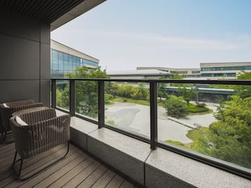 a balcony with a view of a city and trees