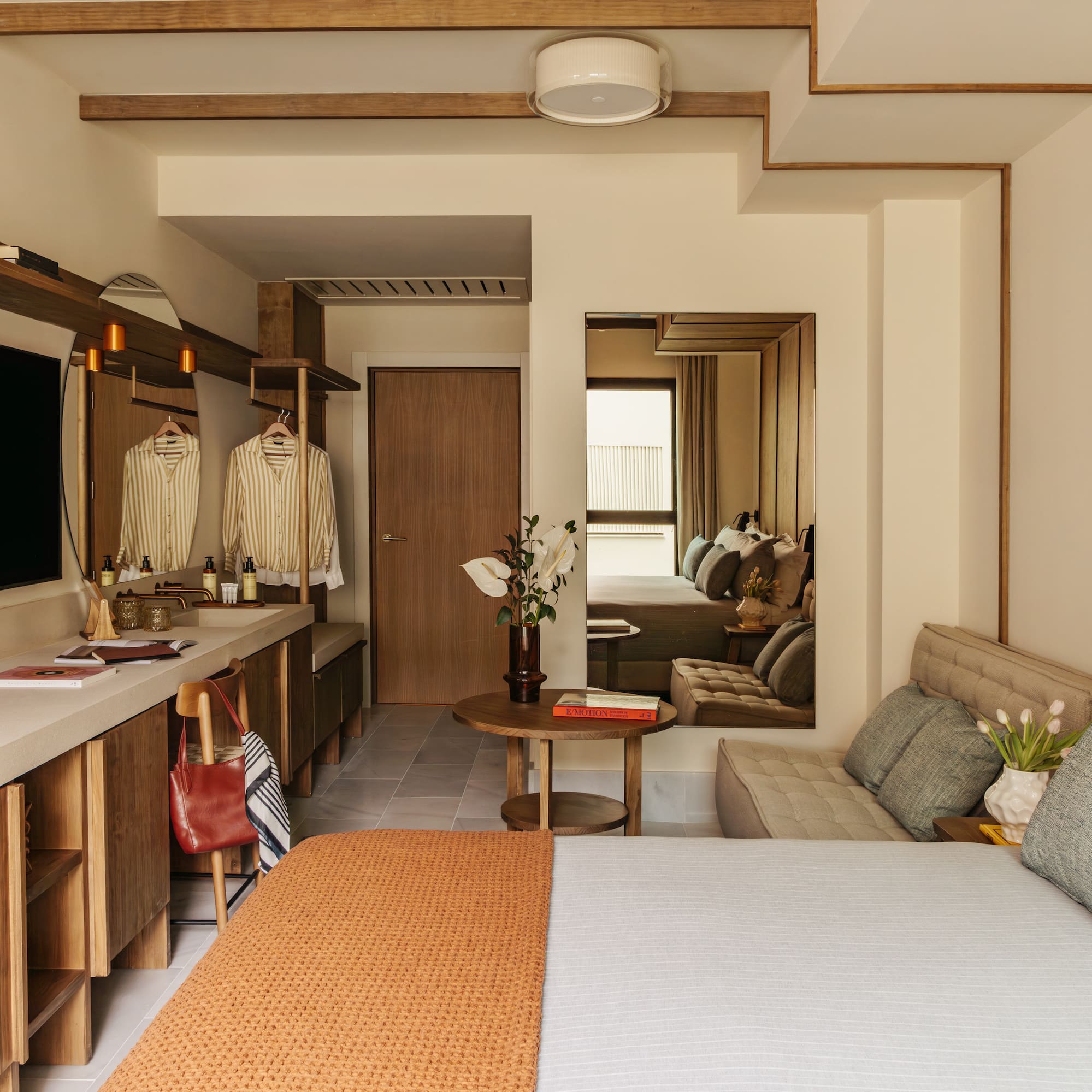 a bedroom with a bed and a mirror