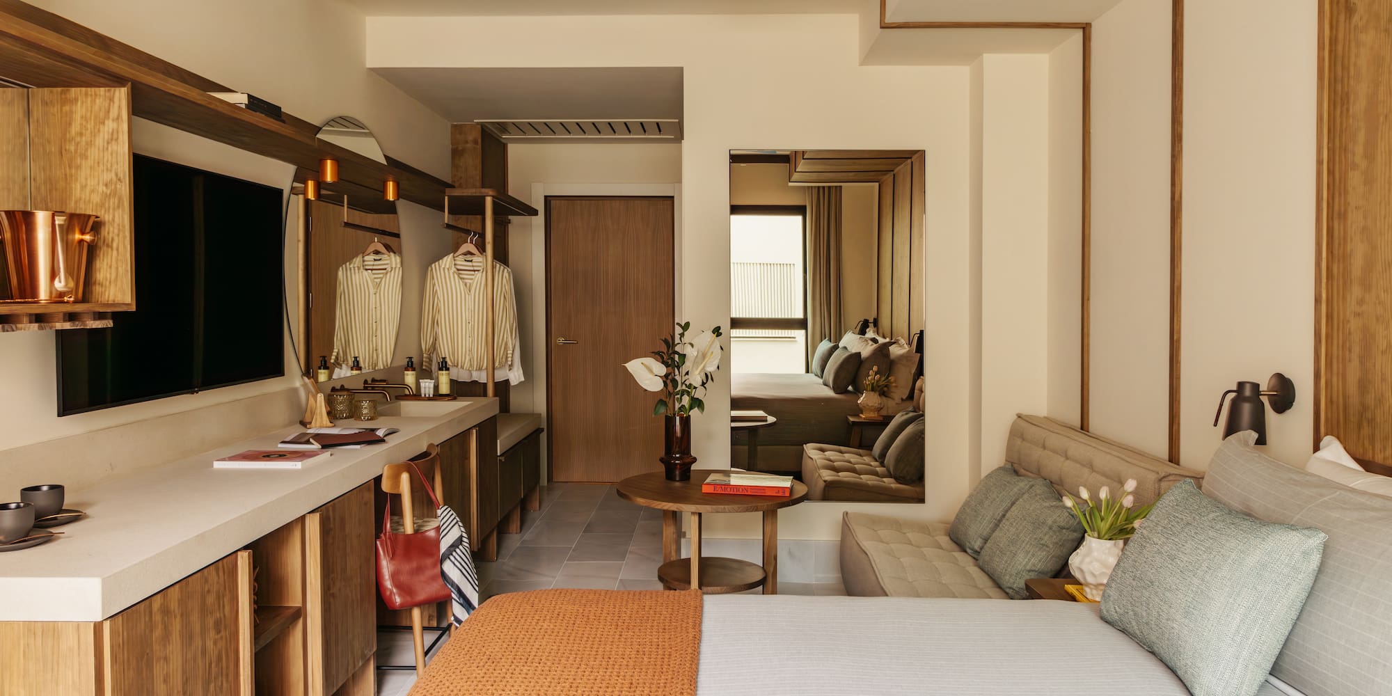 a bedroom with a bed and a mirror