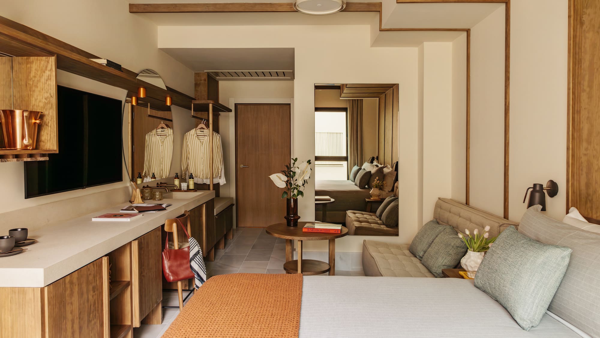 a bedroom with a bed and a mirror