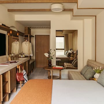 a bedroom with a bed and a mirror