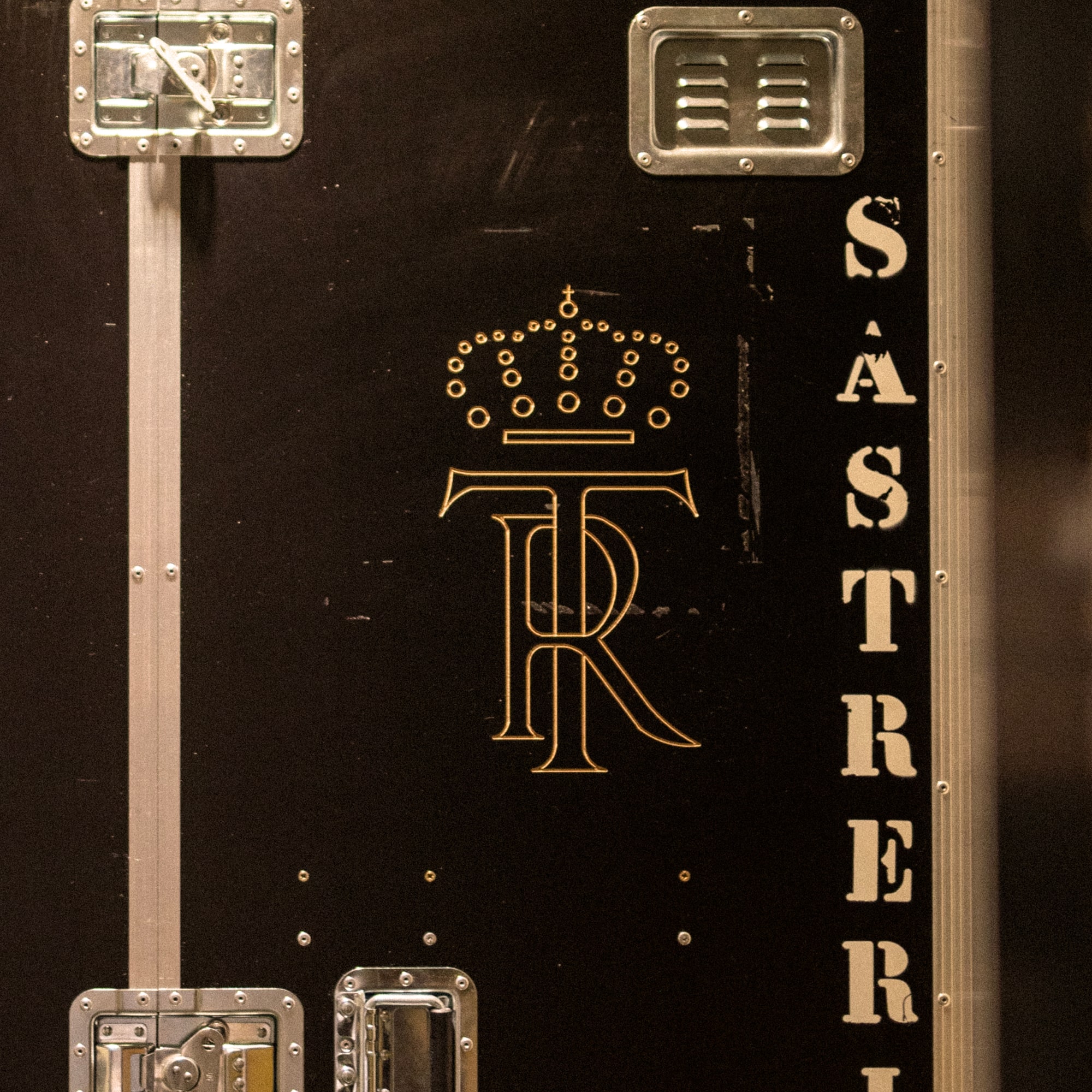 a black box with gold letters and a crown