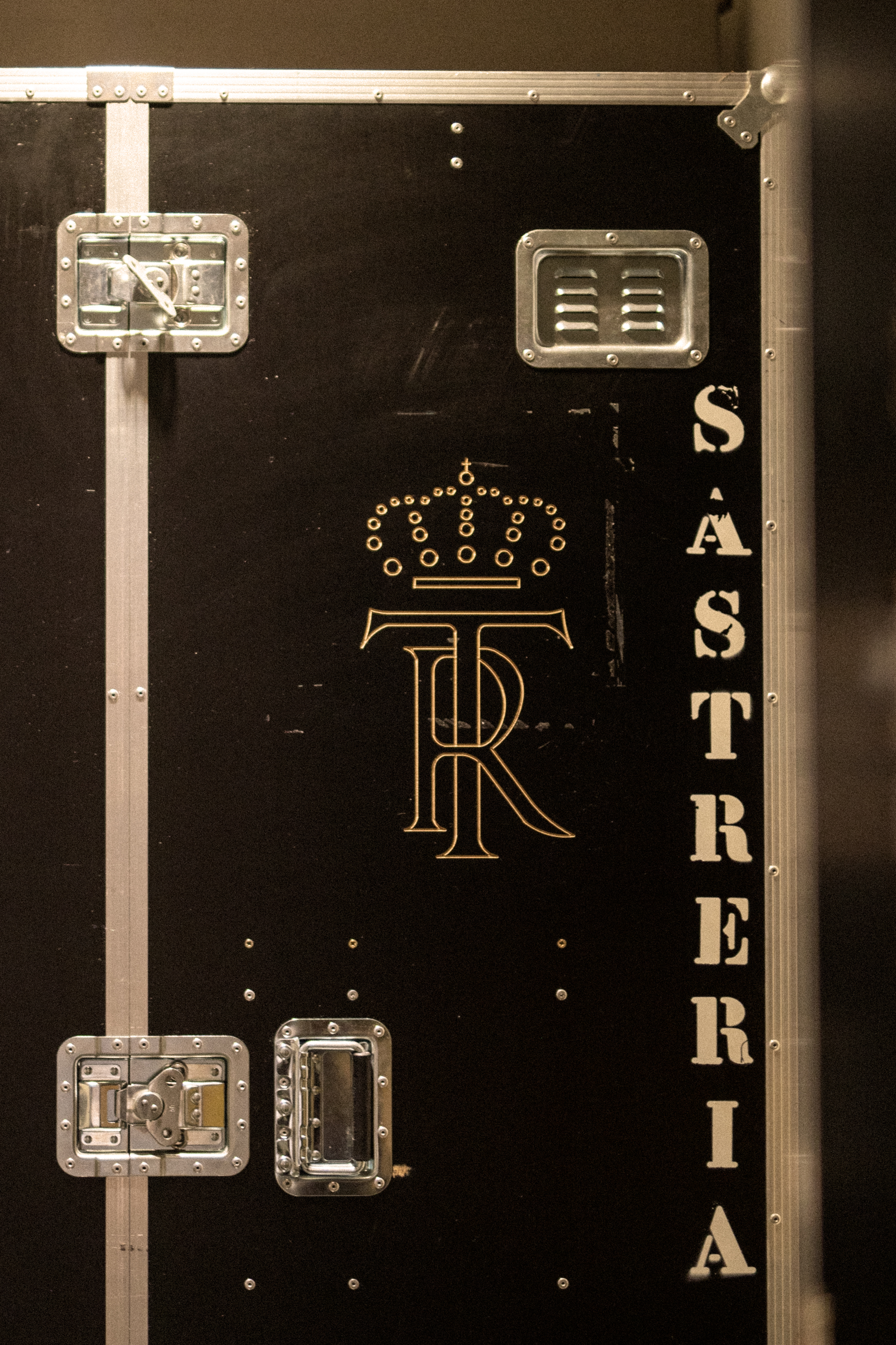 a black box with gold letters and a crown