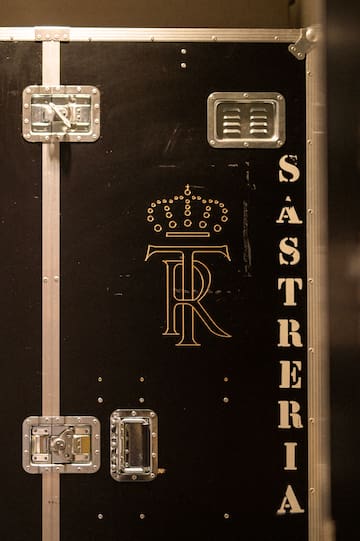 a black box with gold letters and a crown
