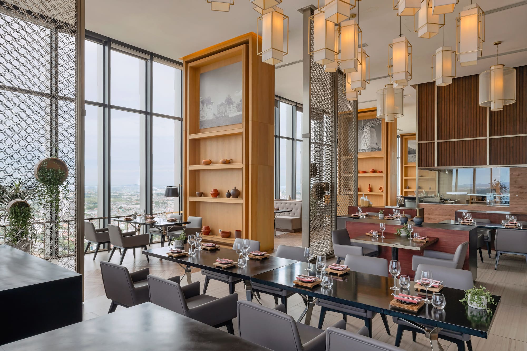 Elegant restaurant with city views, modern design, and stylish table settings.