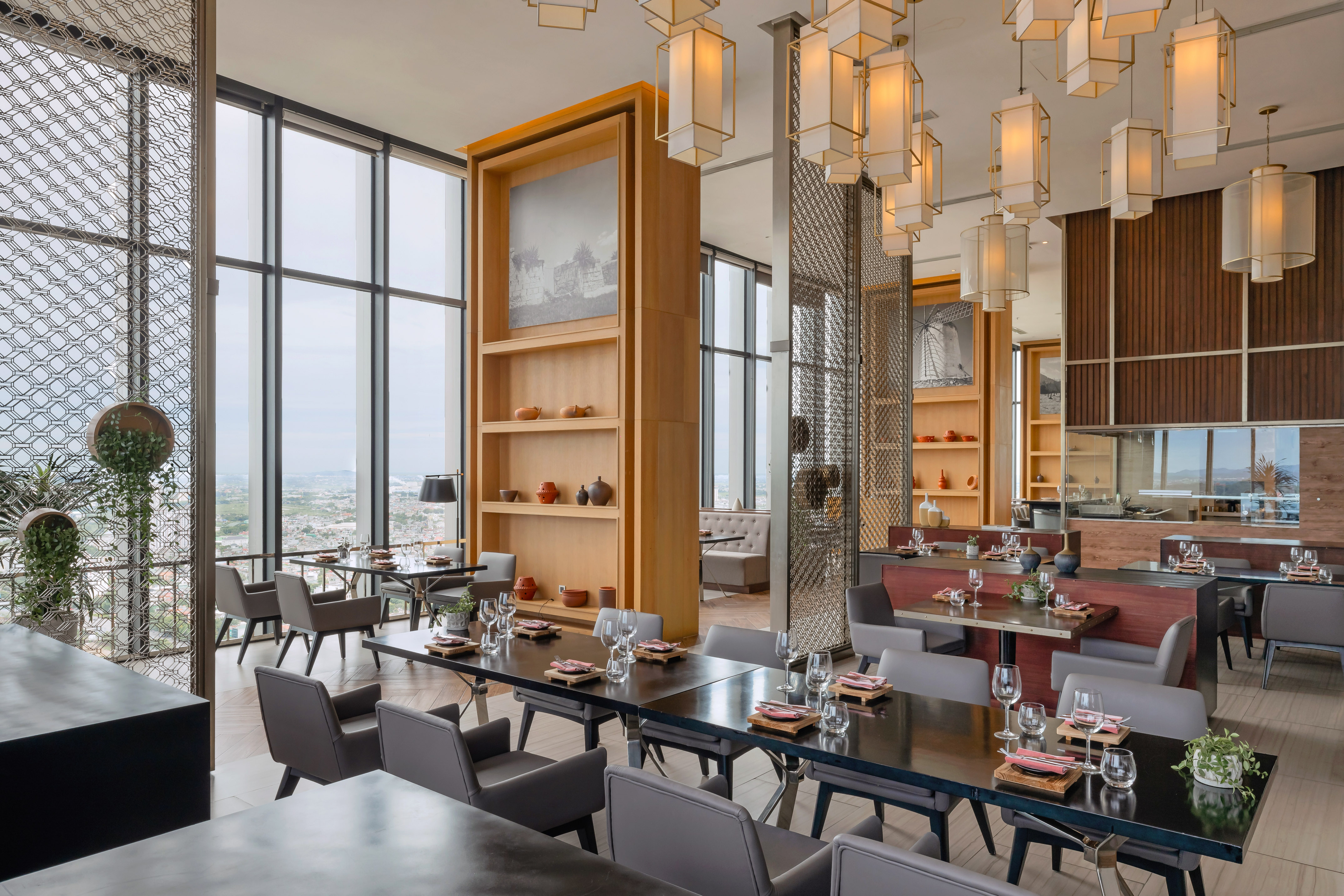 Elegant restaurant with city views, modern design, and stylish table settings.