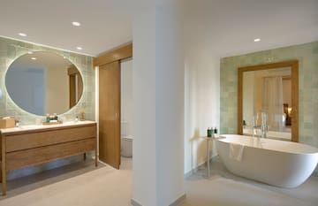 a bathroom with a tub and a mirror