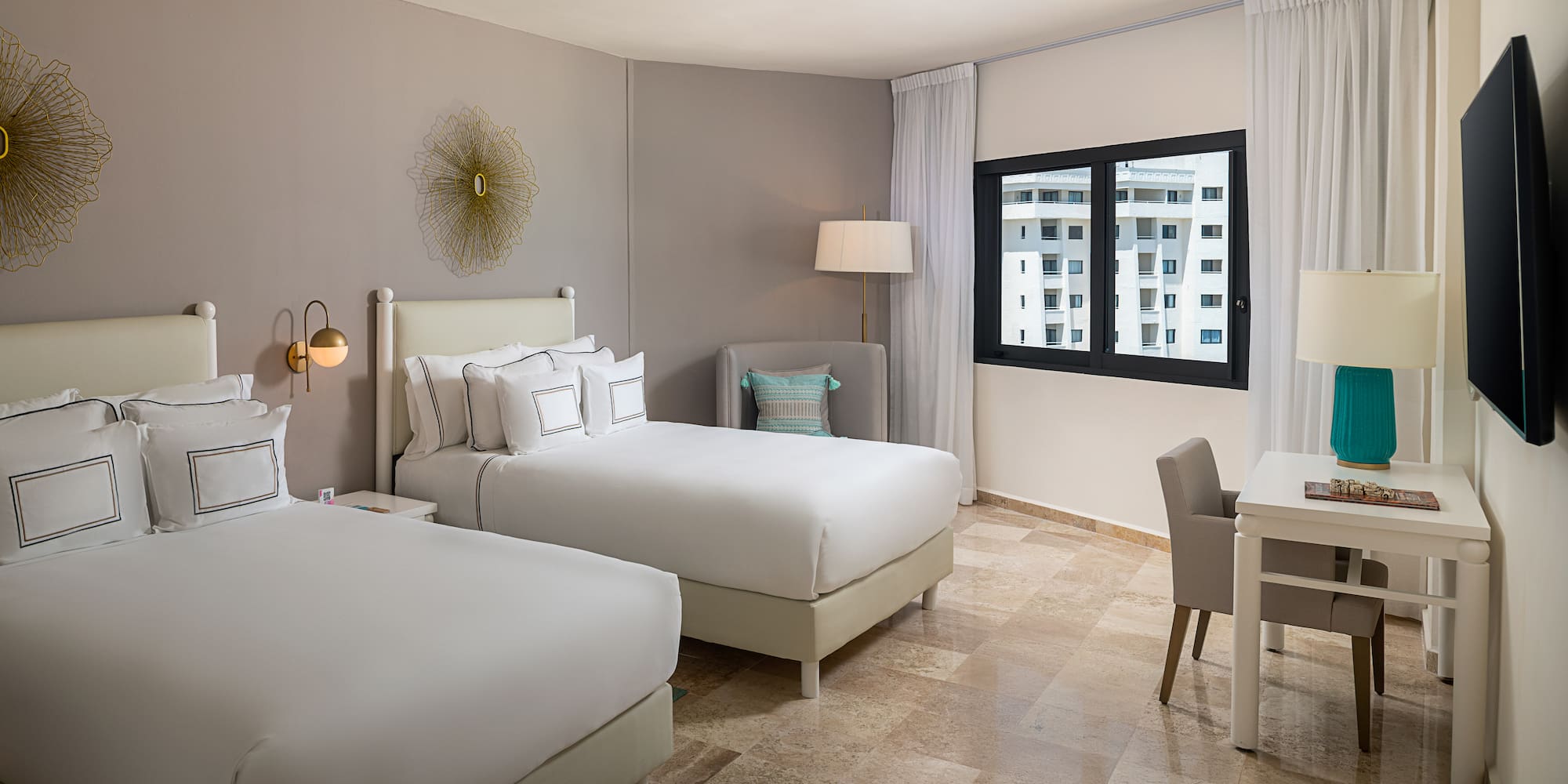 a room with two beds and a desk