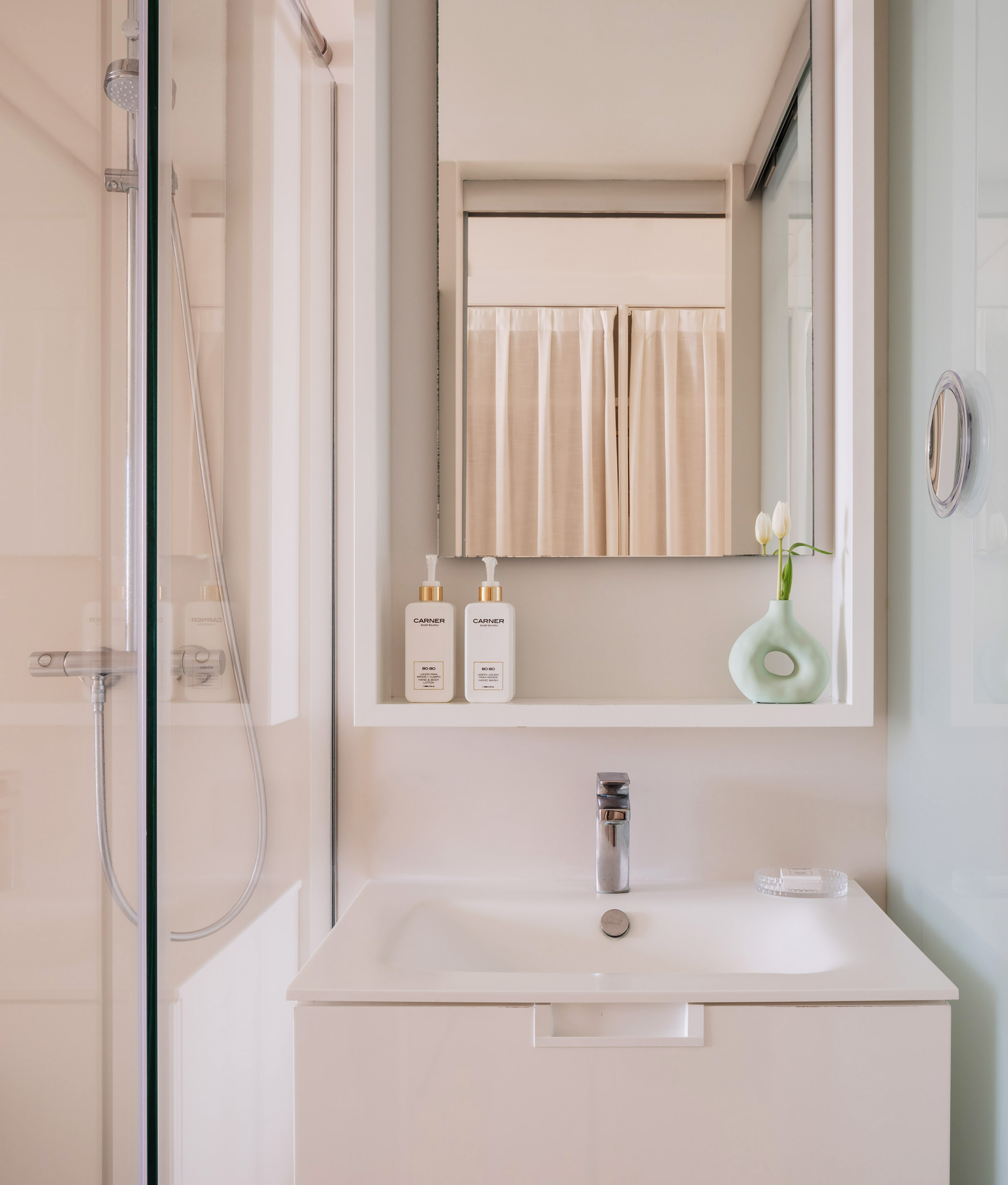 a bathroom with a mirror and a sink