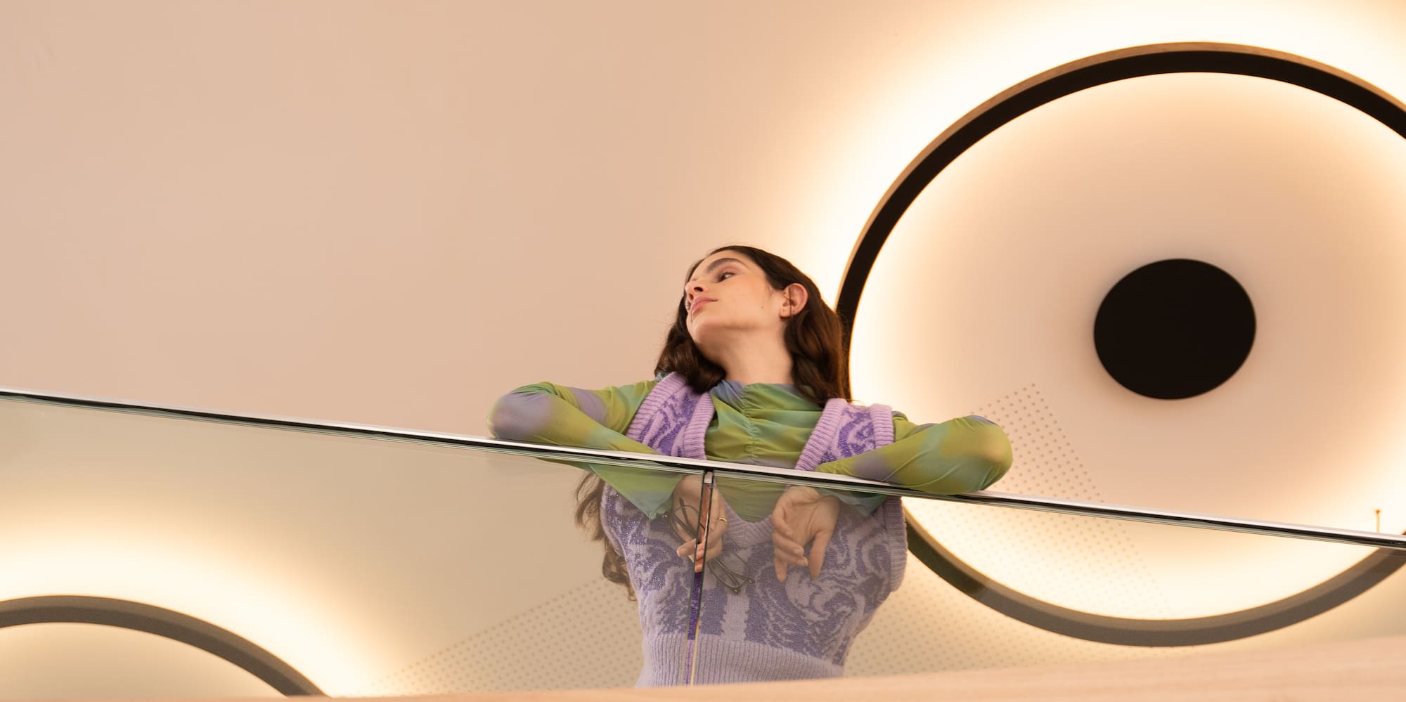 a woman leaning on a railing