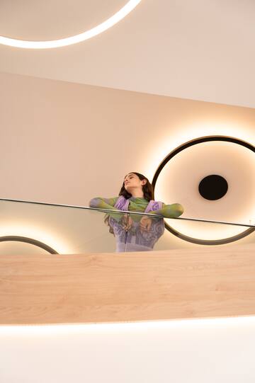 a woman leaning on a railing