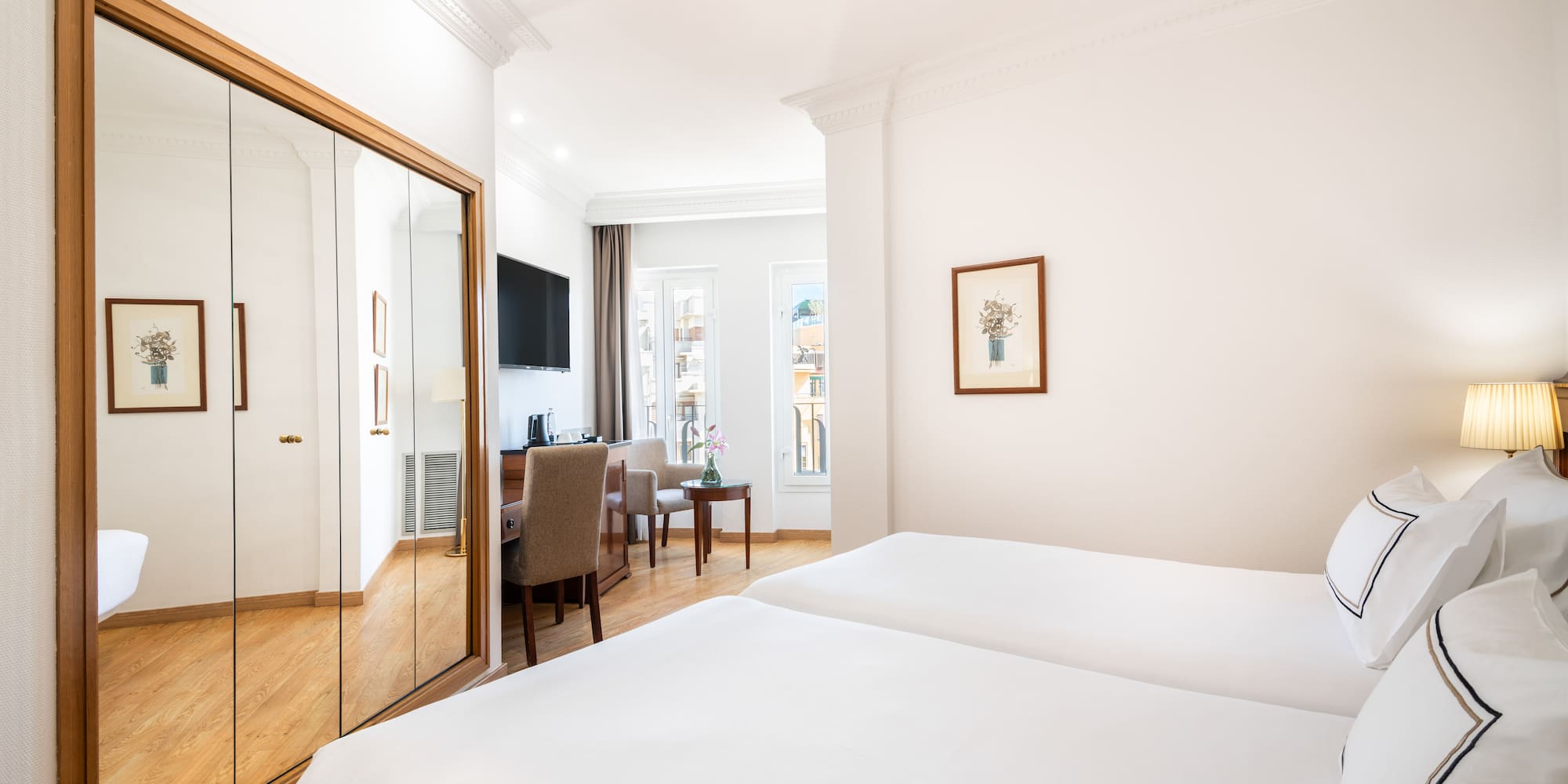 a room with a mirror and a bed