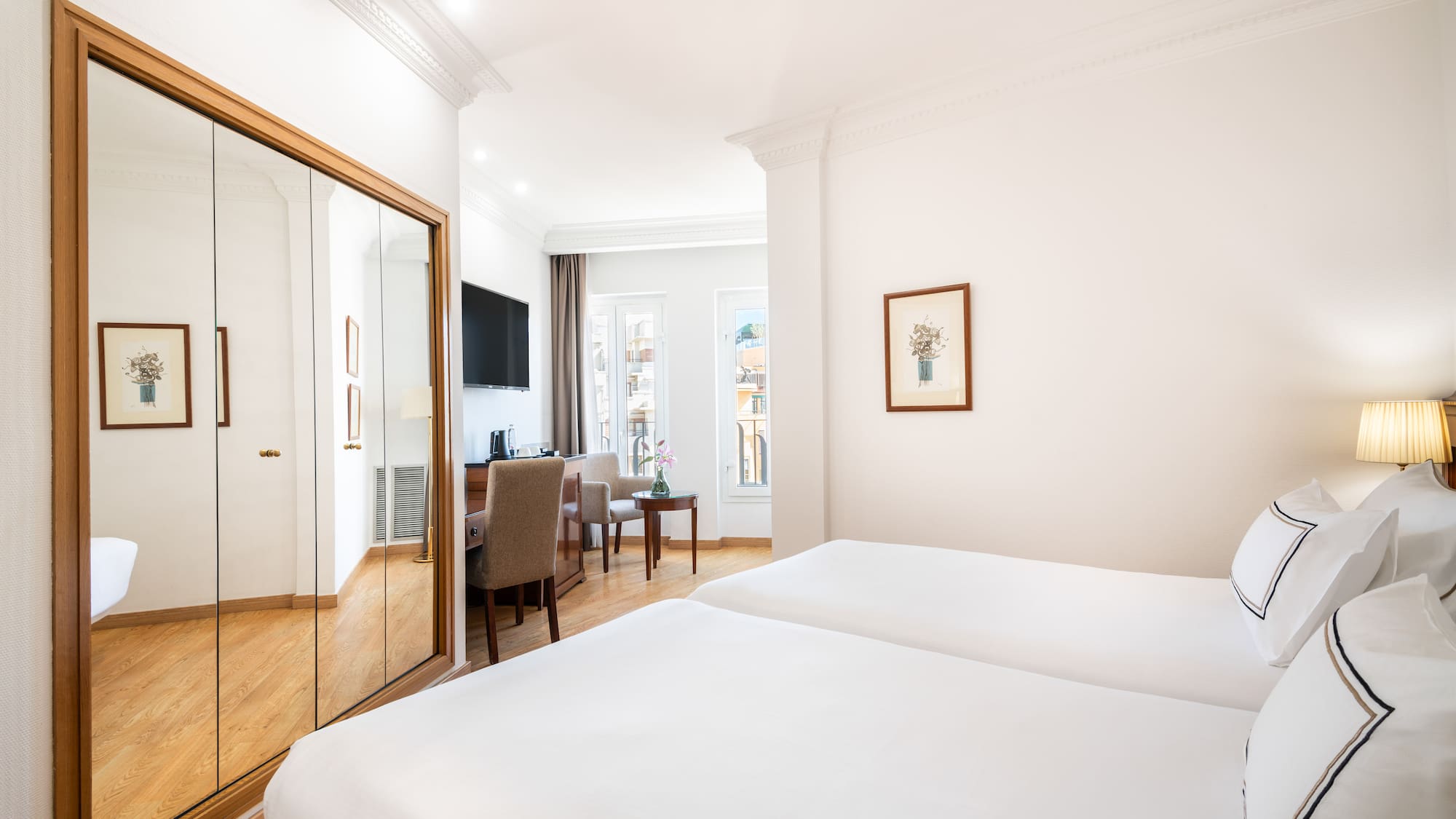 a room with a mirror and a bed