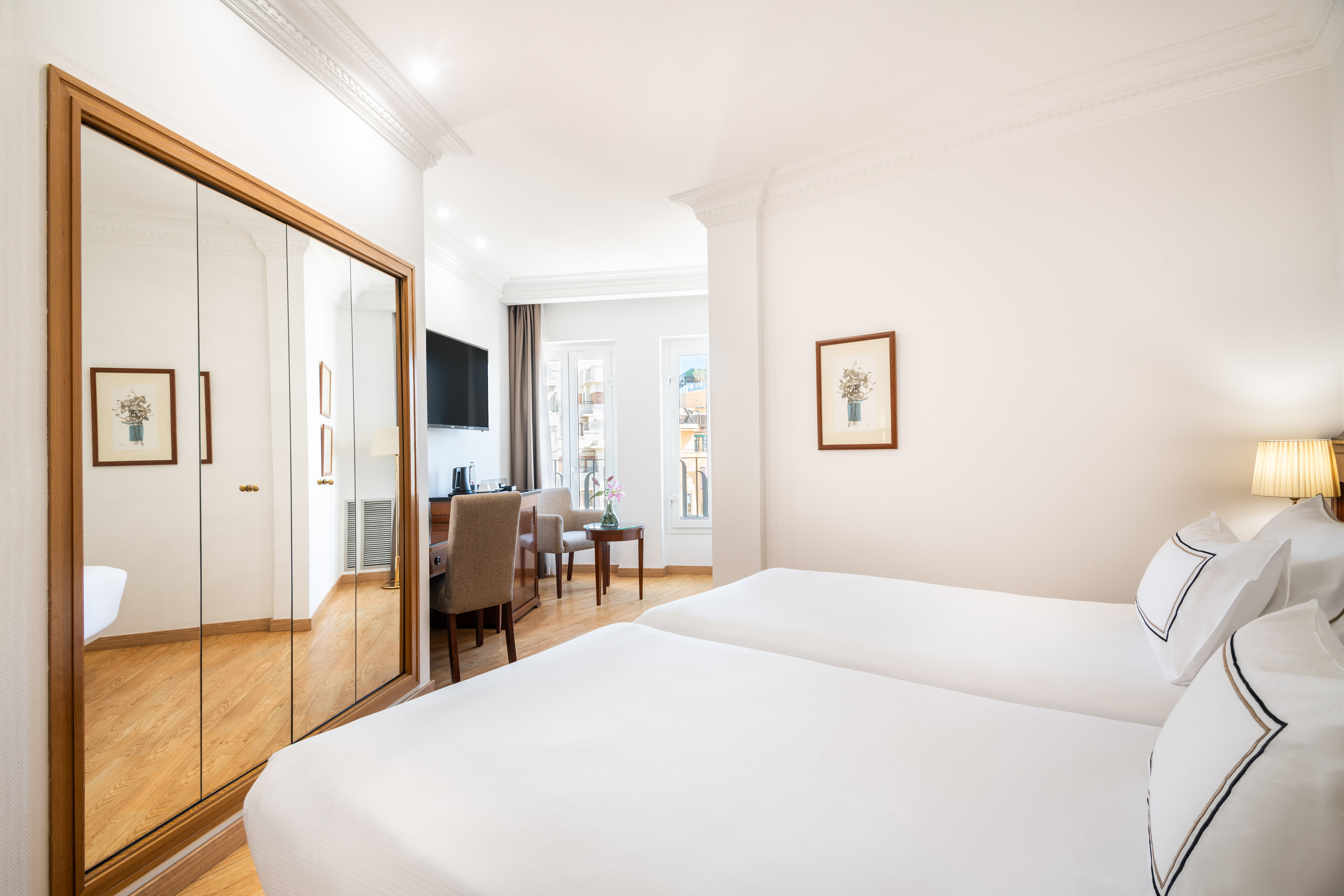 a room with a mirror and a bed