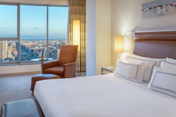 a room with a large window and a bed