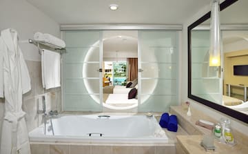 a bathroom with a tub and a mirror