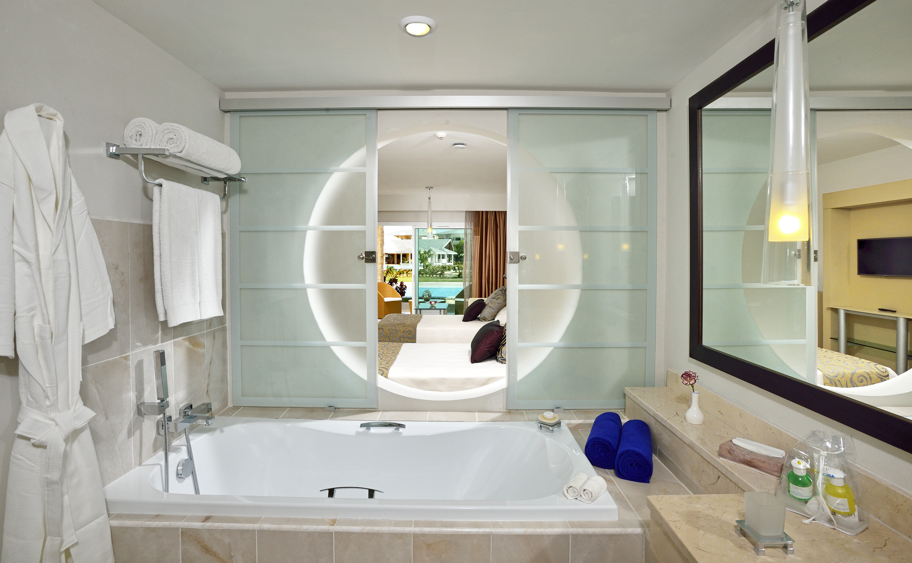 a bathroom with a tub and a mirror