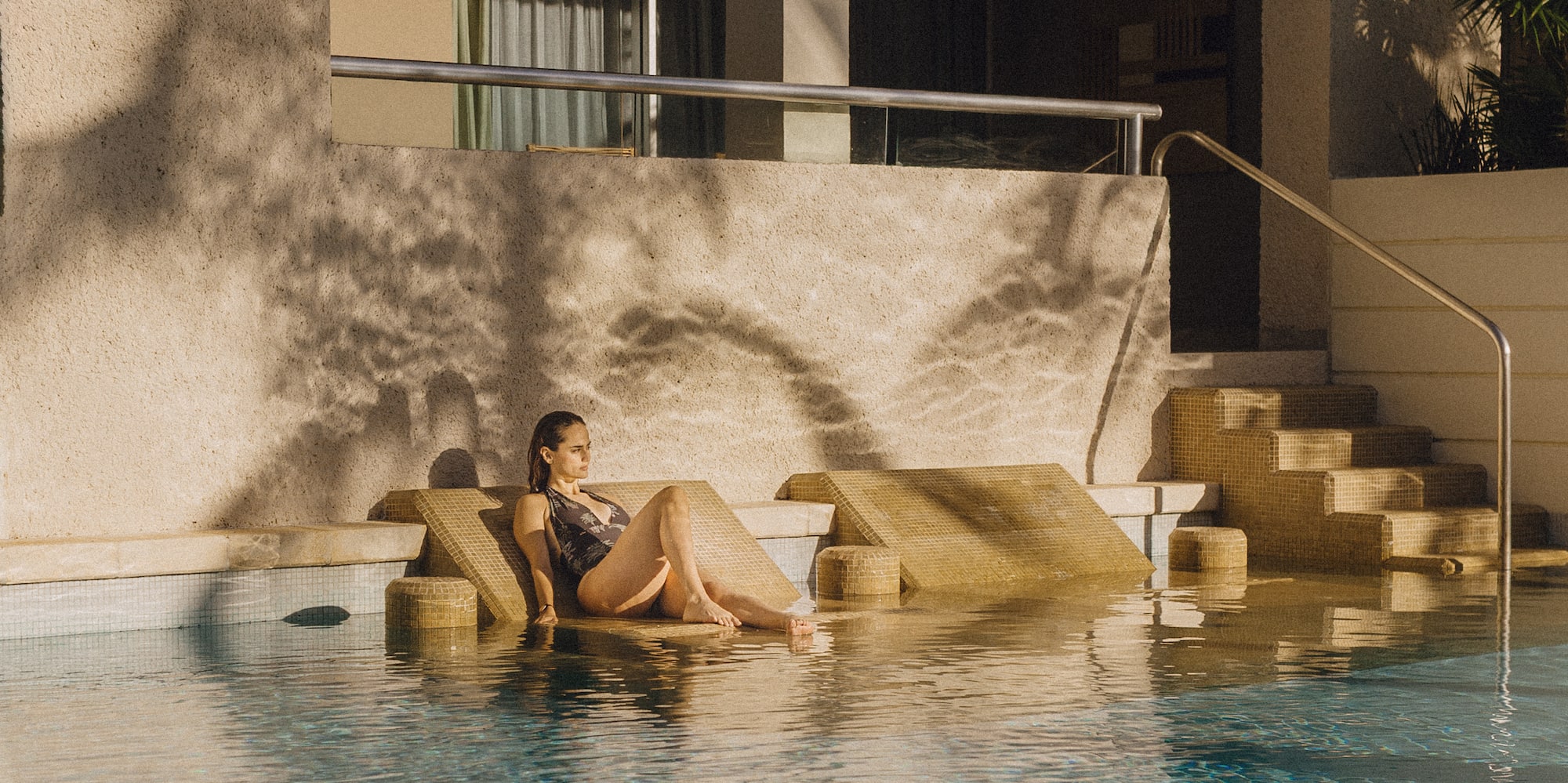 a woman sitting in a pool
