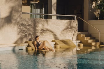 a woman sitting in a pool