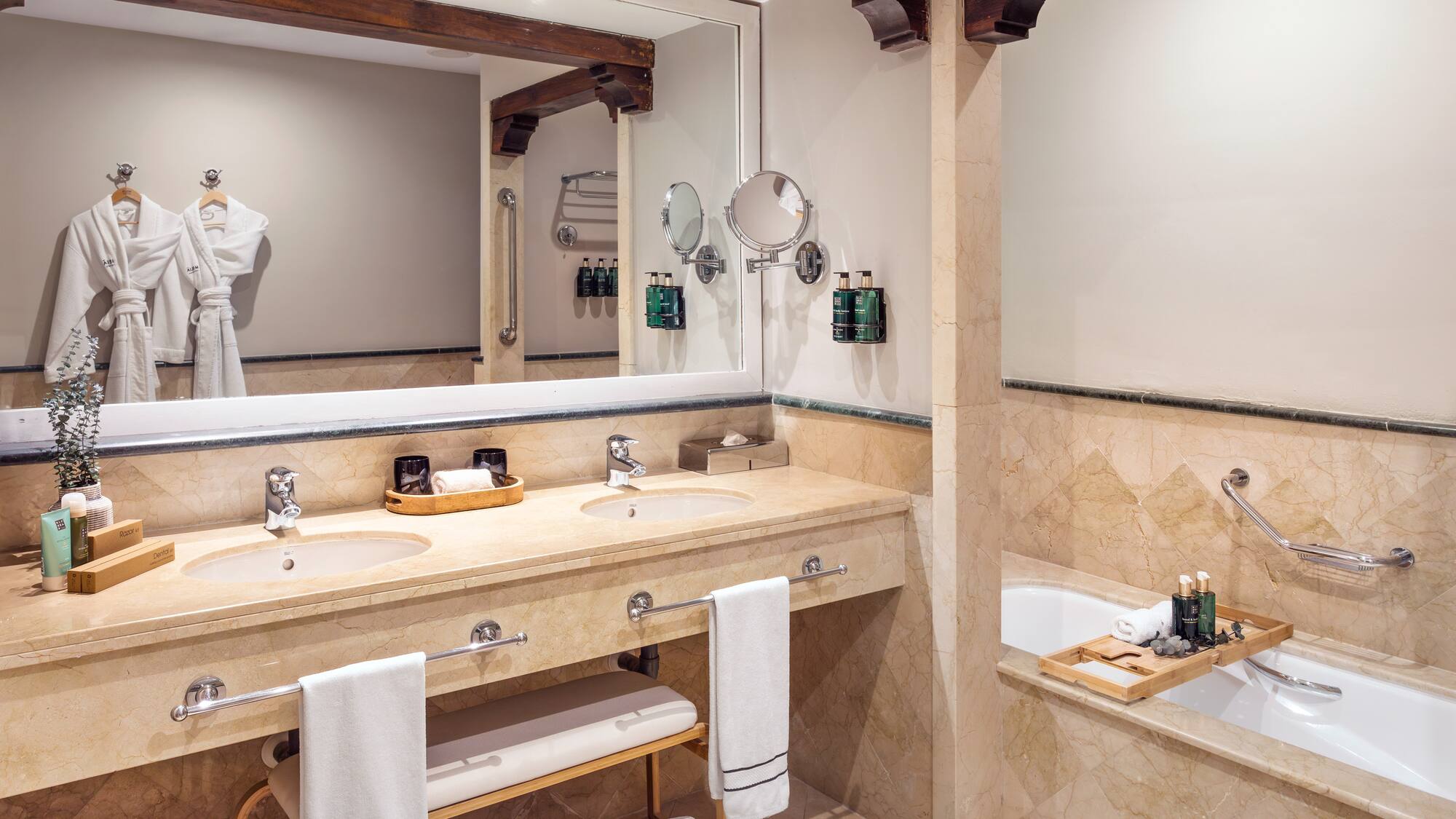 a bathroom with a large mirror and a tub