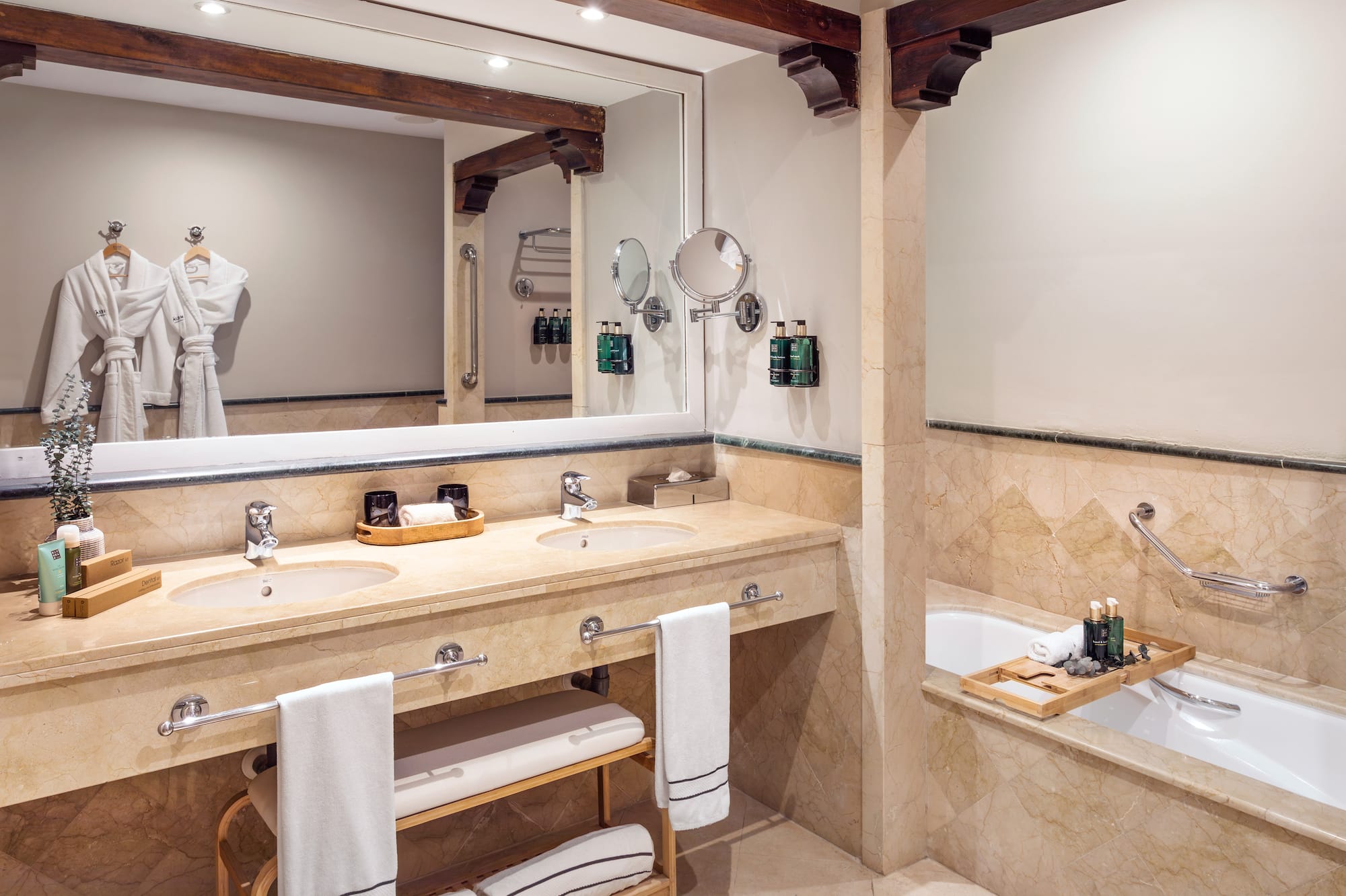 a bathroom with a large mirror and a tub