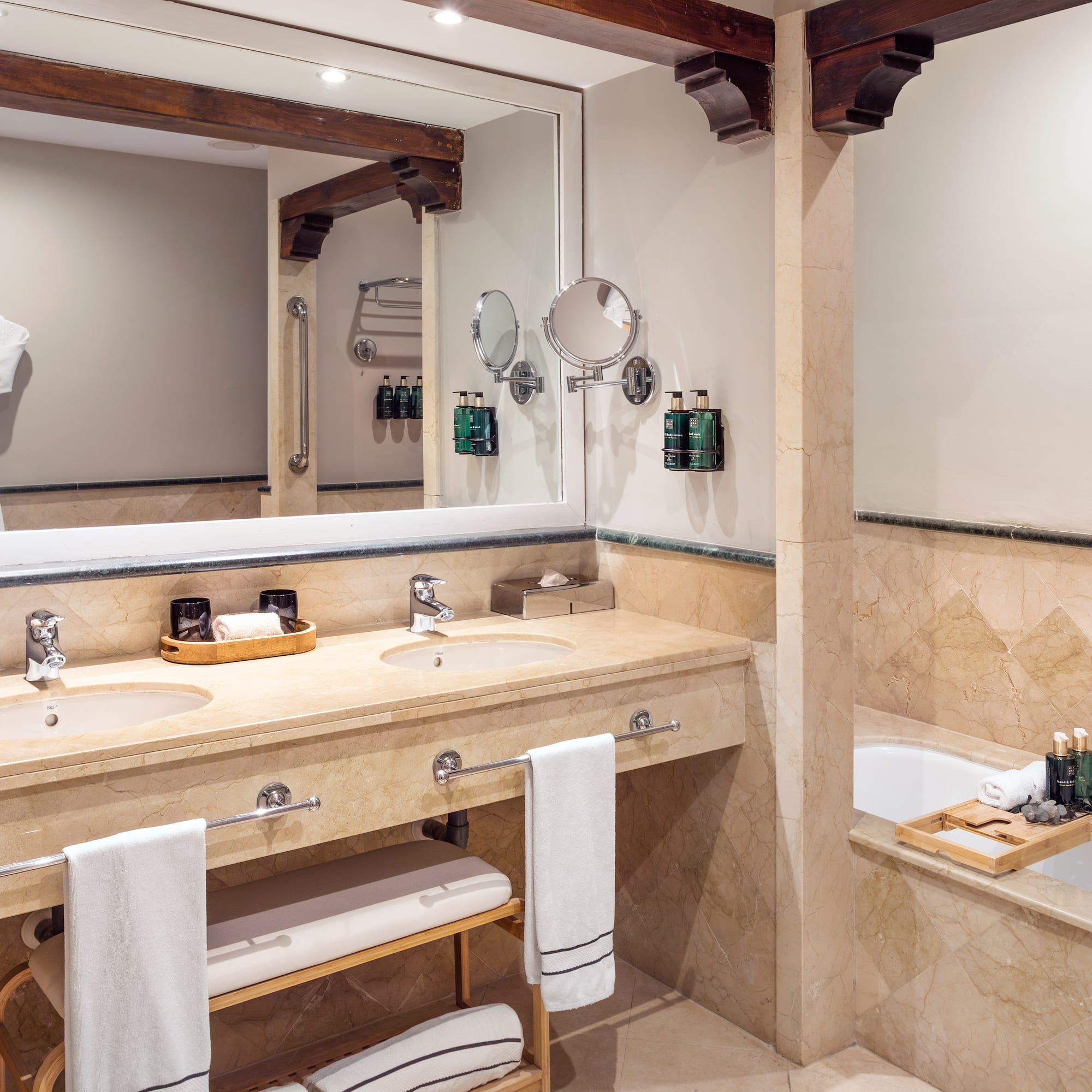 a bathroom with a large mirror and a tub
