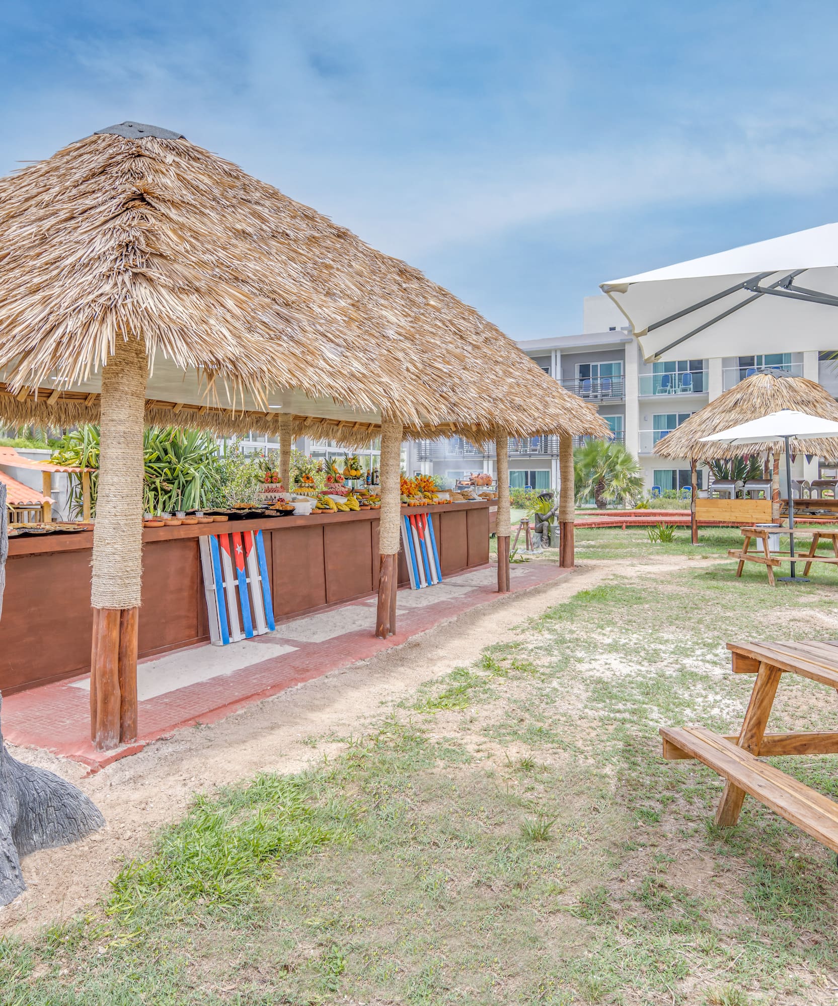 a picnic table and umbrellas in a yard