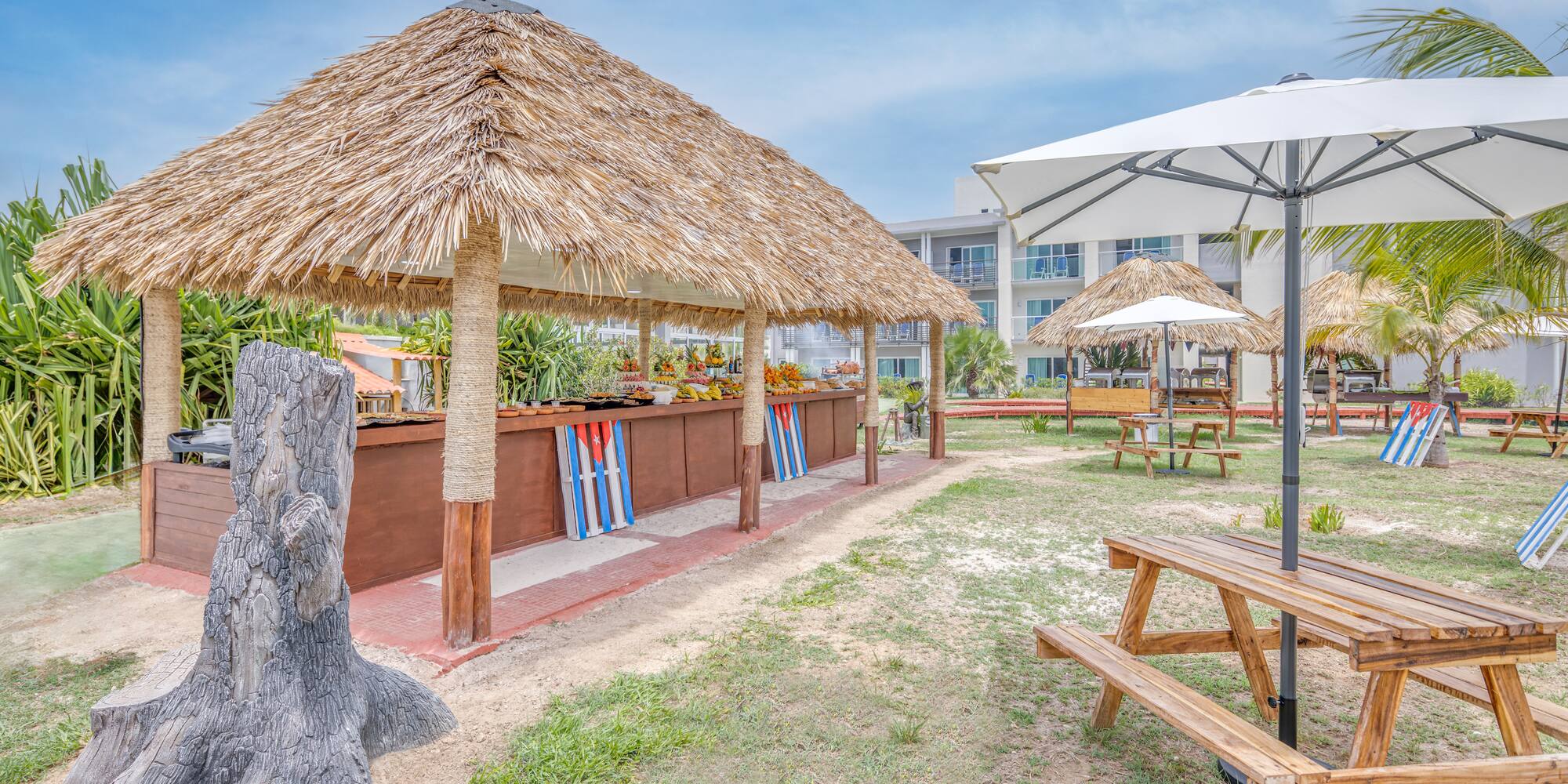 a picnic table and umbrellas in a yard