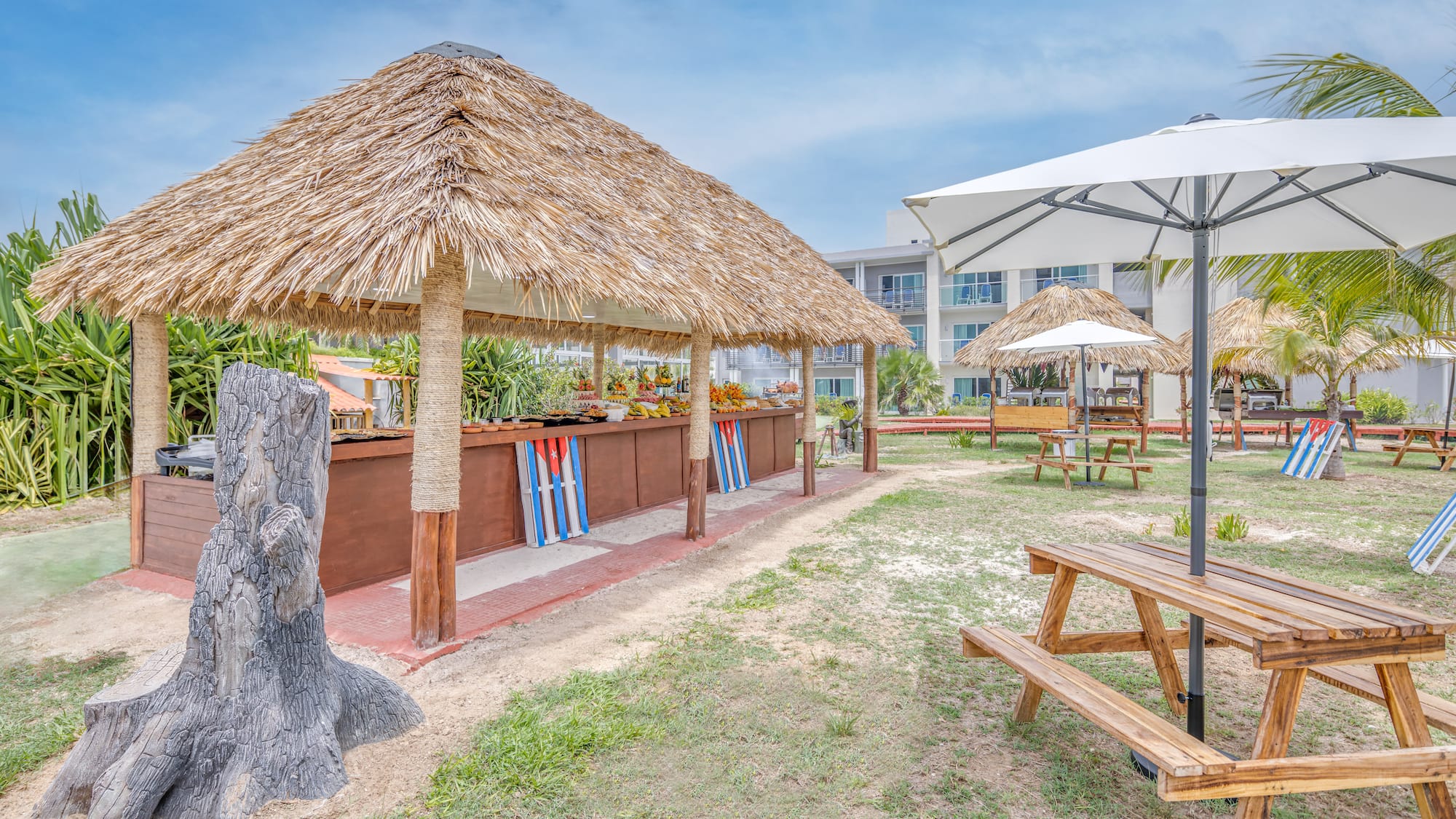 a picnic table and umbrellas in a yard